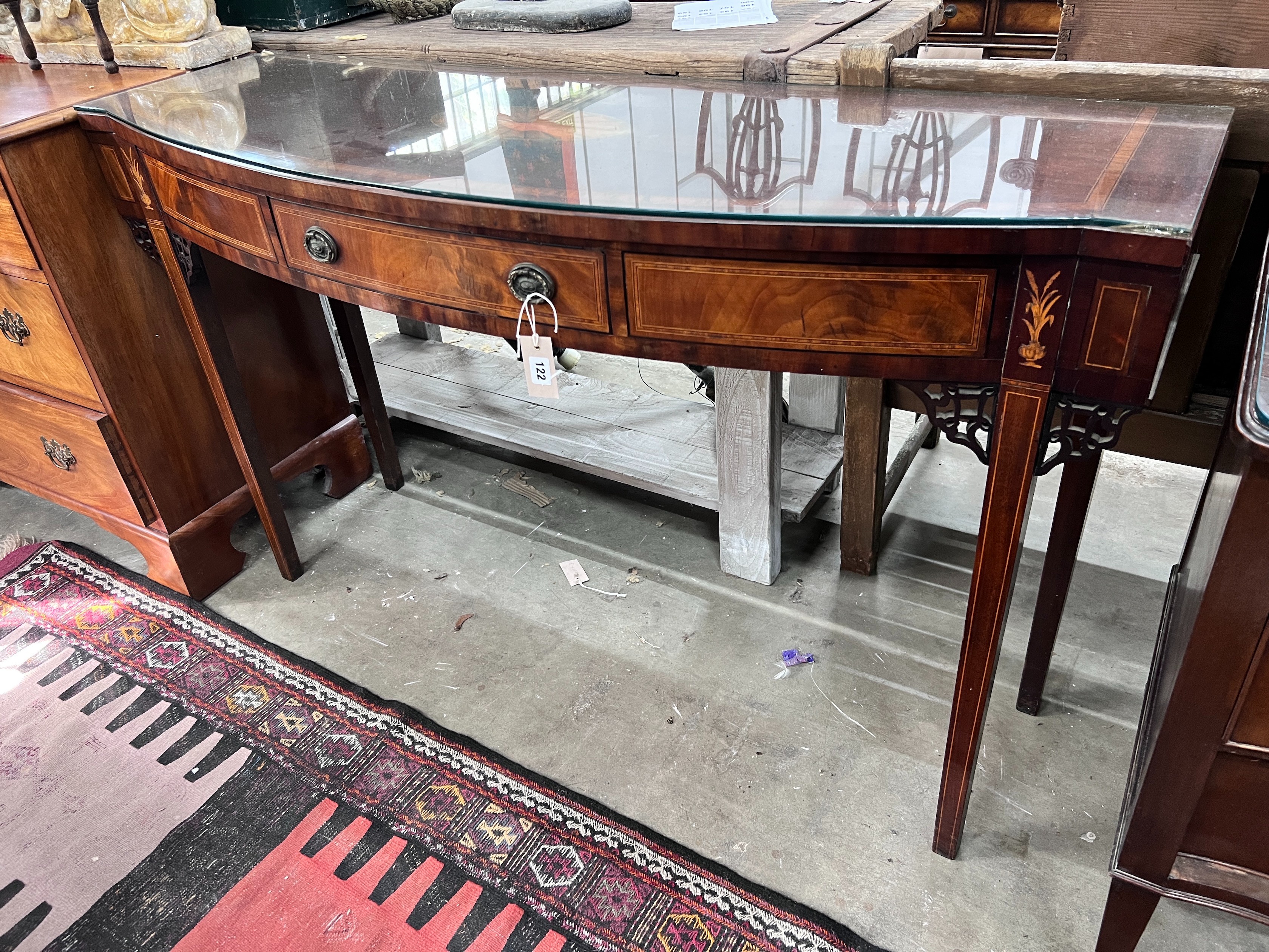A George III inlaid mahogany bow front serving table, length 140cm, depth 47cm, height 84cm *Please note the sale commences at 9am.                                                                                         