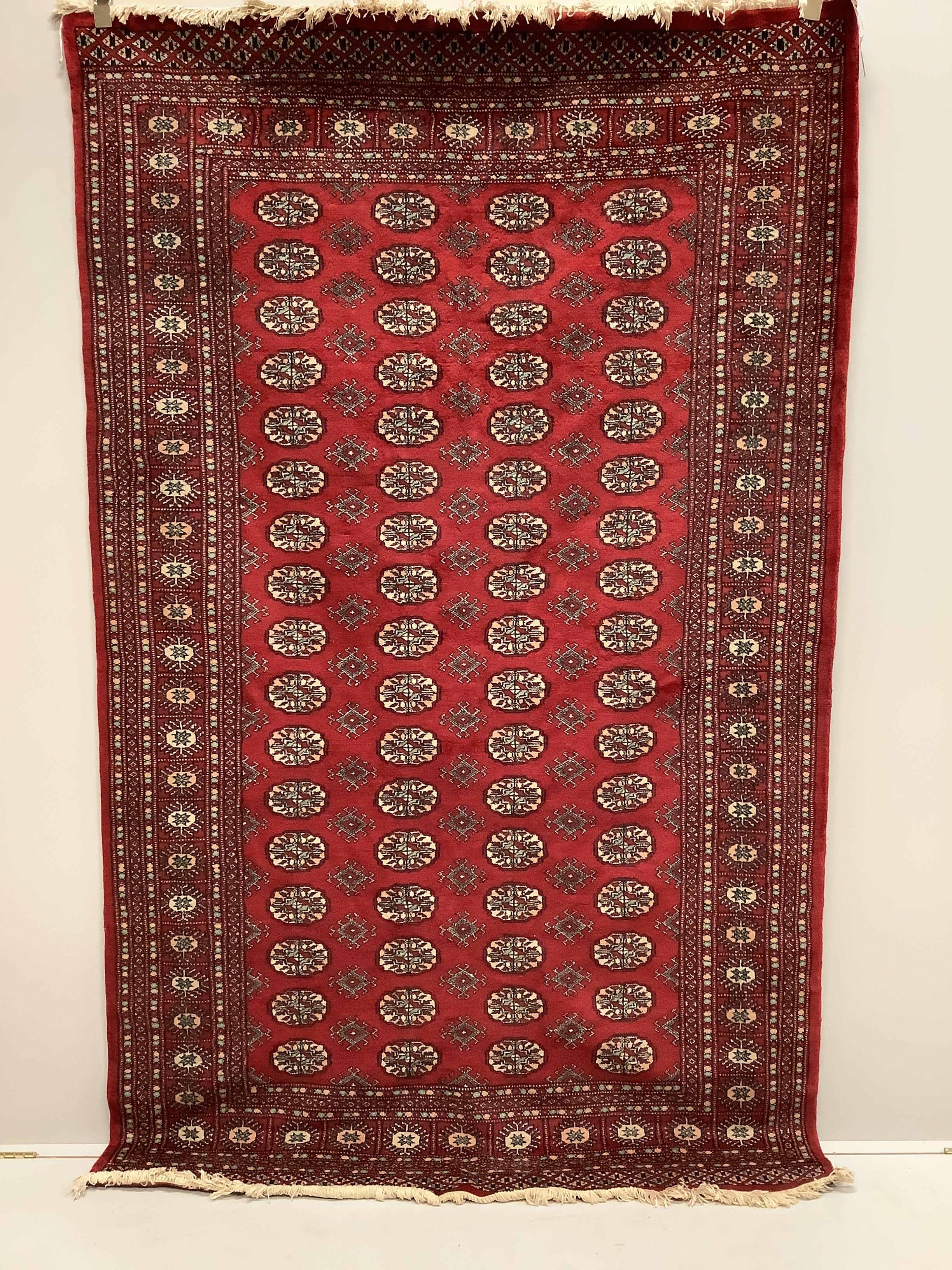A Bokhara red ground rug, 250 x 155cm                                                                                                                                                                                       