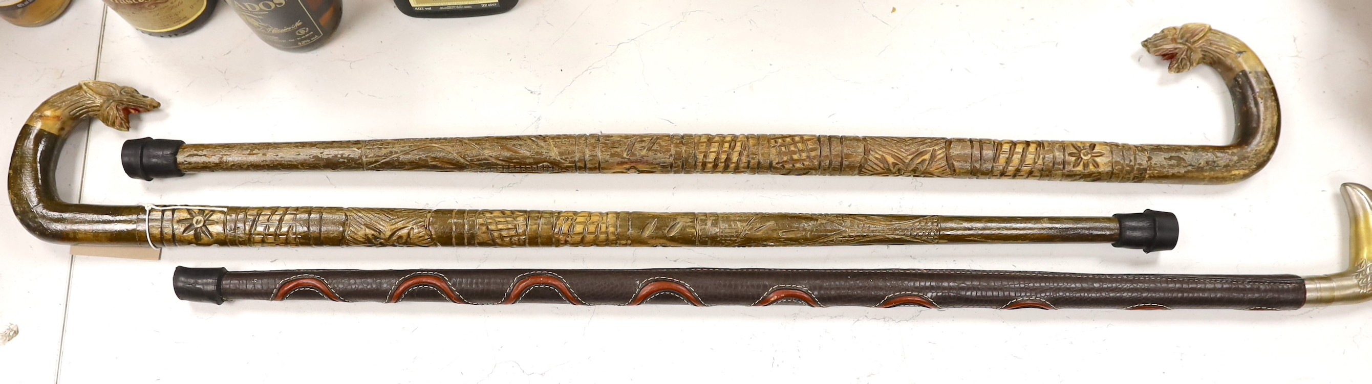 Three ornamental walking sticks. Largest 93cm tall                                                                                                                                                                          