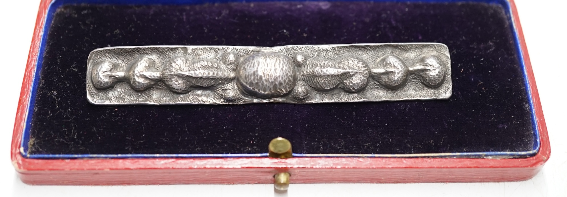 A white metal rectangular brooch, with embossed decoration, 90mm. Condition - fair                                                                                                                                          