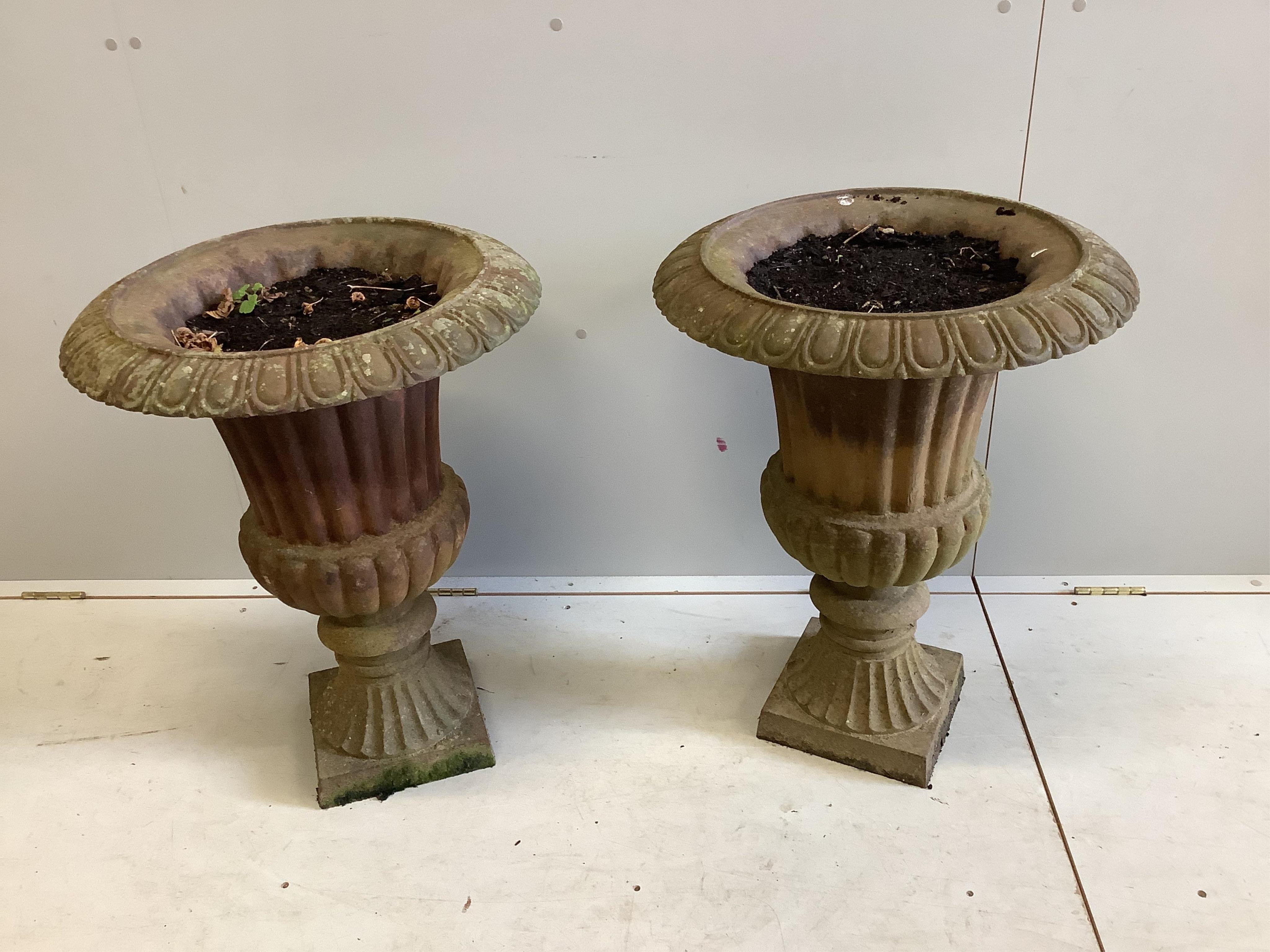 A pair of cast iron campana garden urns, diameter 53cm, height 70cm. Condition - fair                                                                                                                                       