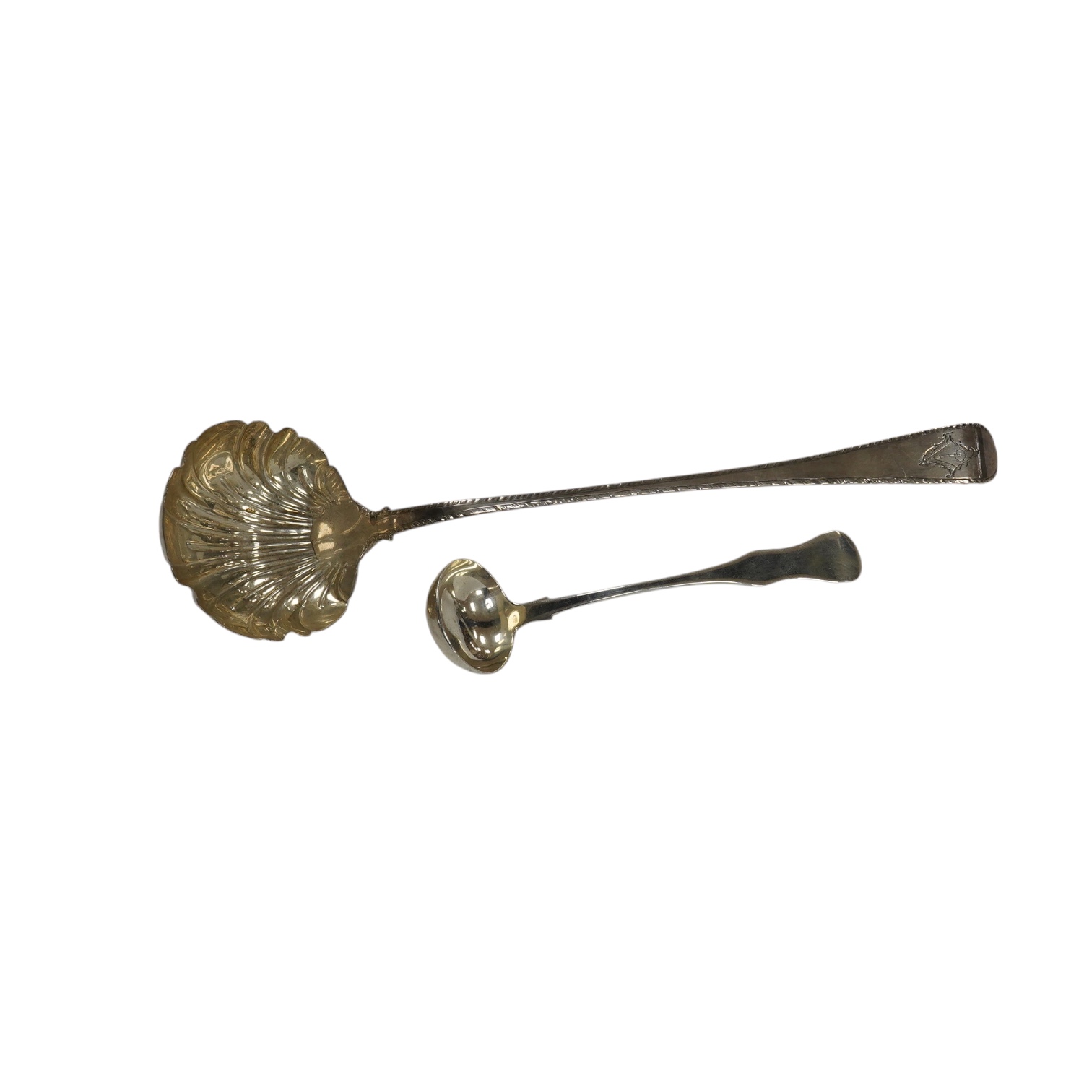 An early George III silver Old English feather edge pattern soup ladle, George Baskerville, London, 1766, together with a Victorian Scottish silver sauce ladle, 6.1 oz. Condition - poor to fair                           