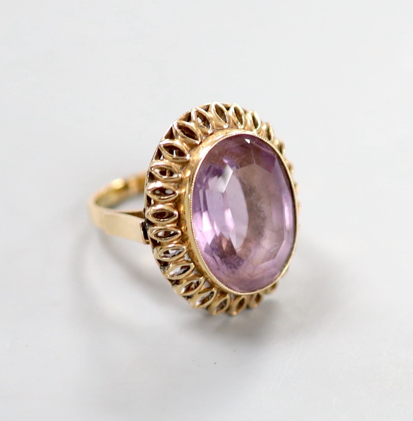 A continental 14k yellow metal and oval cut amethyst set dress ring, size M, gross weight 8.5 grams.                                                                                                                        