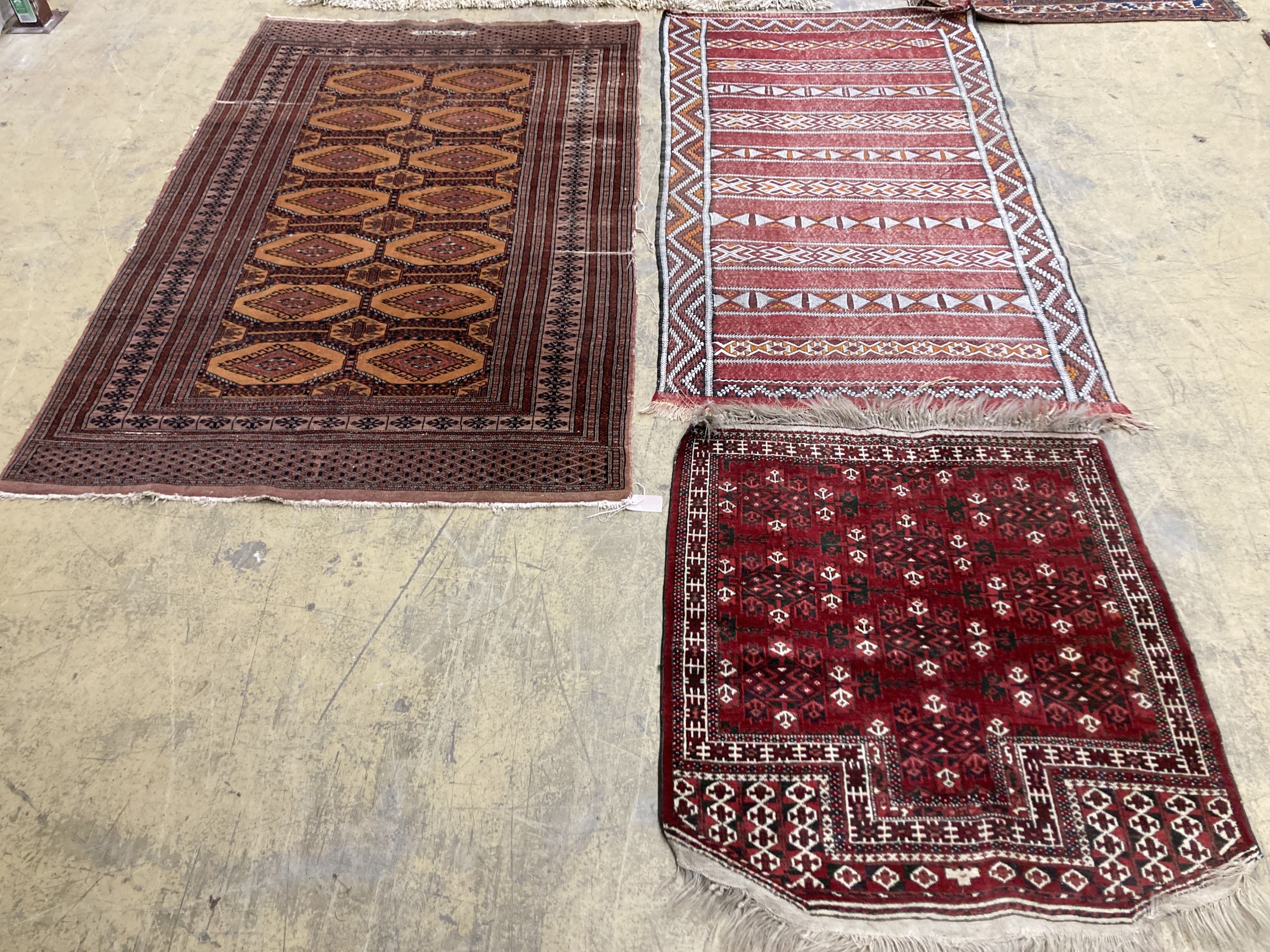 A Bokhara orange ground rug 198 x 125 cms, a smaller Anatolian flat weave rug and Bokhara prayer mat.                                                                                                                       