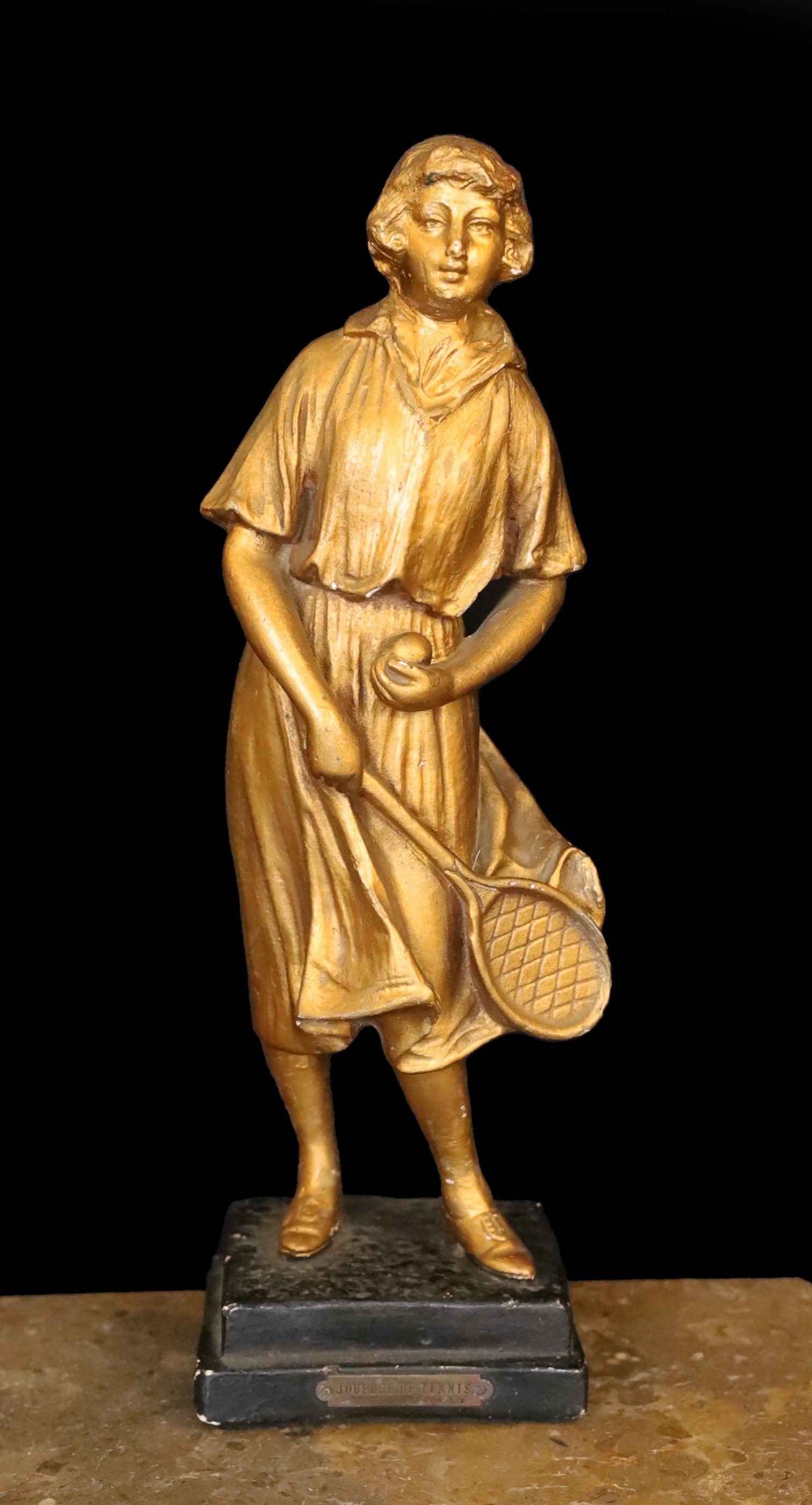 A 1930s French gilt plaster figure of a tennis player ‘Joueuse de Tennis’, height 42cm                                                                                                                                      