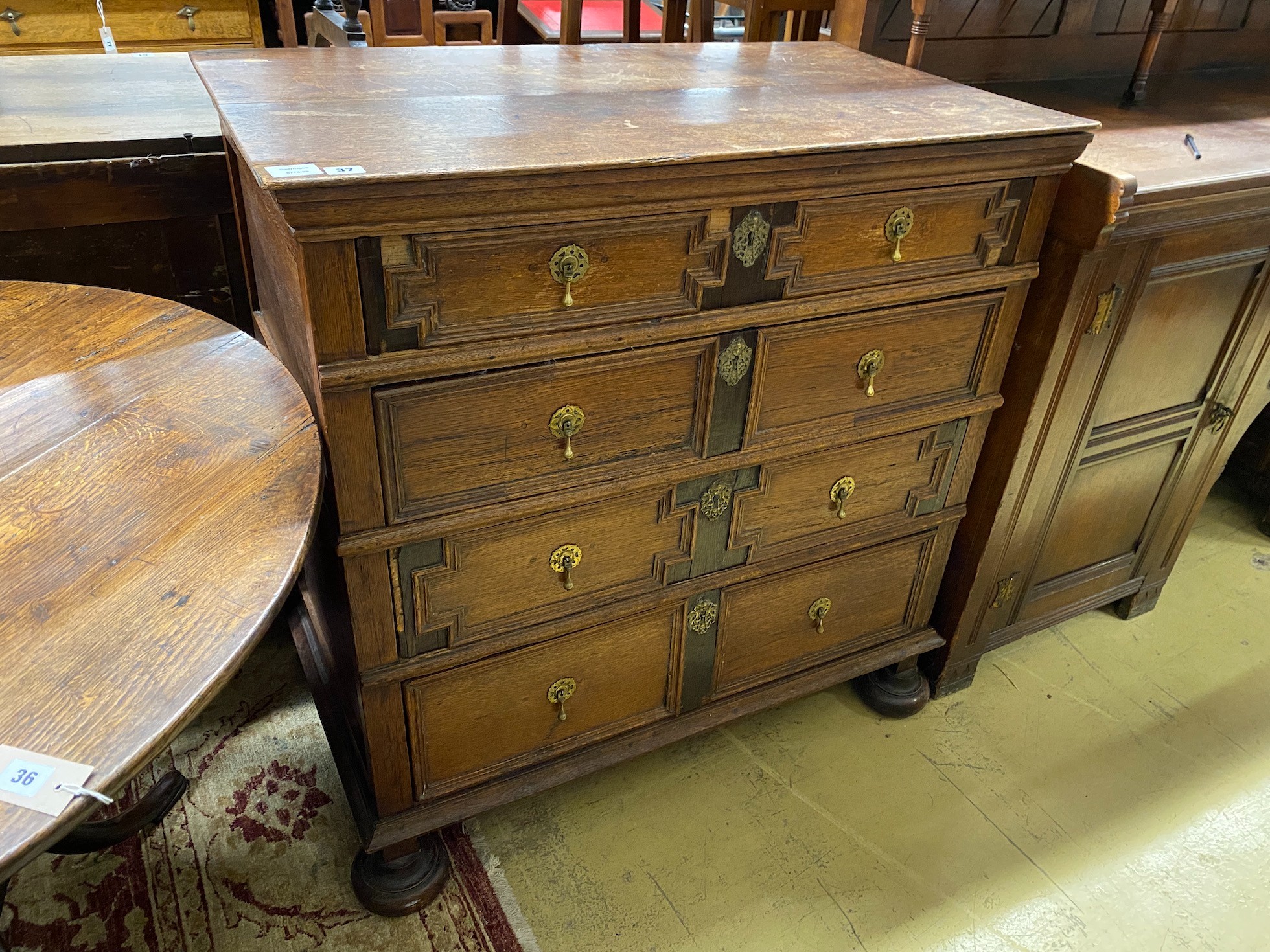 A 17th century style oak geometric four drawer chest, width 97cm, depth 54cm, height 99cm                                                                                                                                   