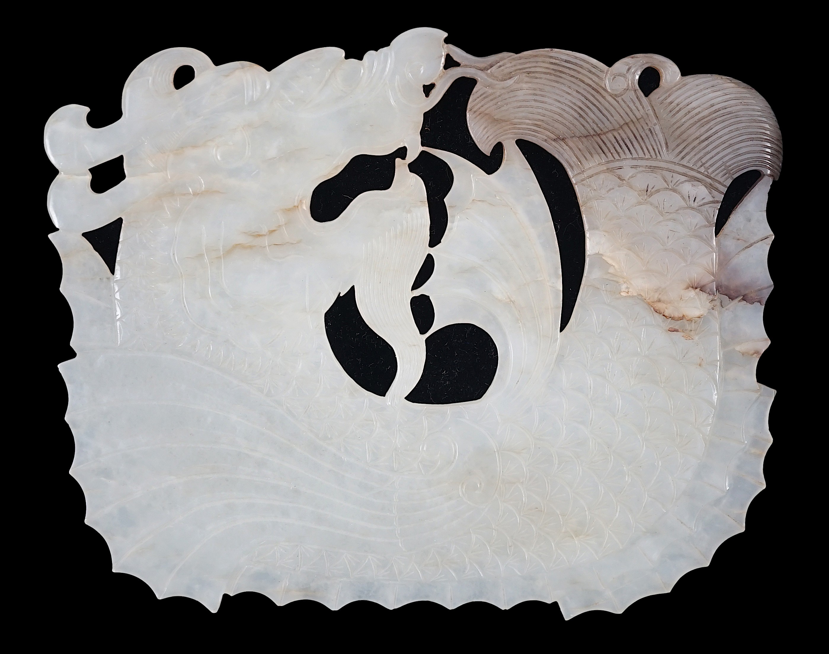 A Chinese late Ming white and grey jade ‘dragon-fish’ plaque, 17th century, 11.7cm wide, 9.3cm high                                                                                                                         