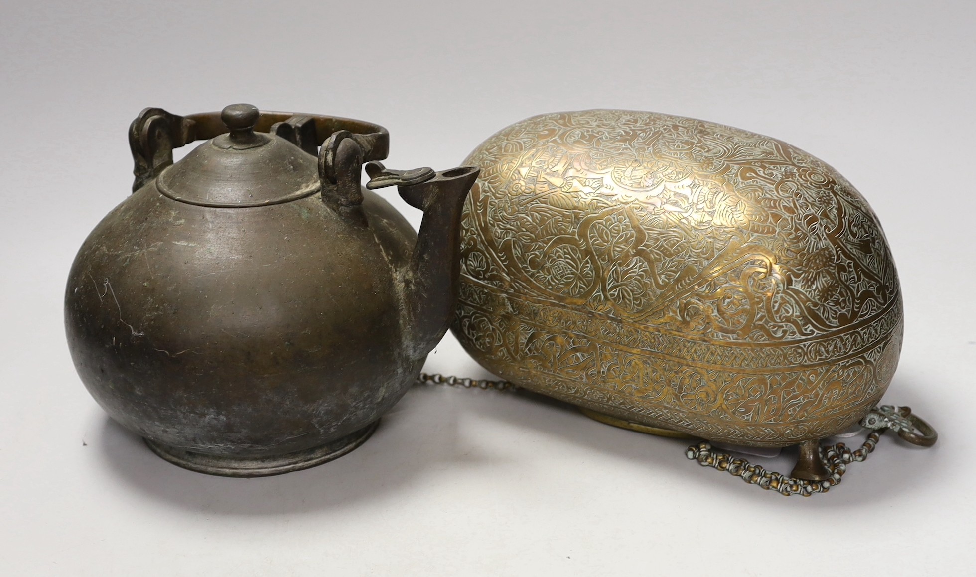 A 19th century Persian engraved brass kashkul, Qajar dynasty, 16cm wide and a bronze kettle, 17cm tall                                                                                                                      