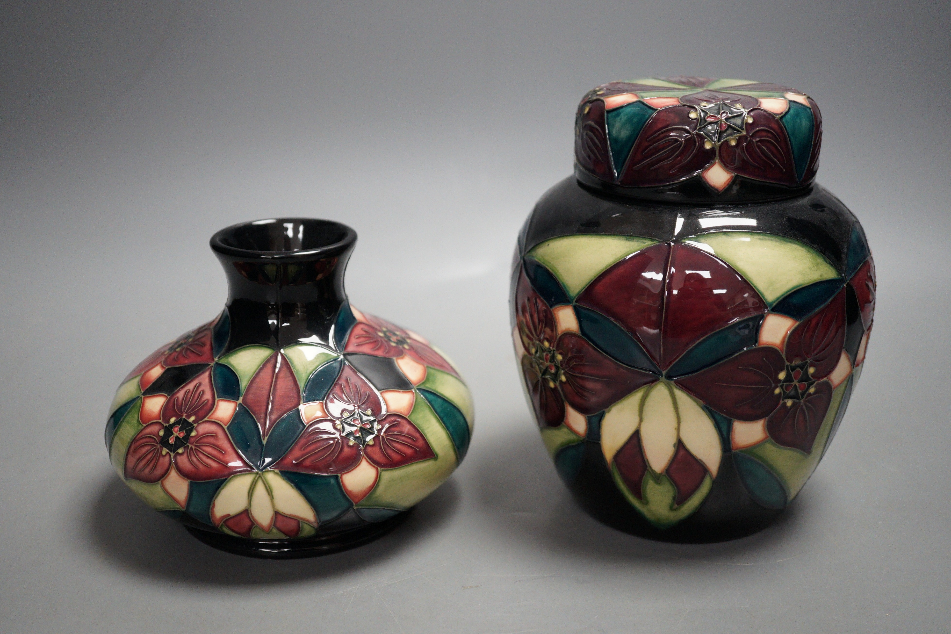 A Moorcroft pottery squat shaped vase and lidded ginger jar, decorated in the "Orchid Trillium" pattern, tallest 15cm                                                                                                       