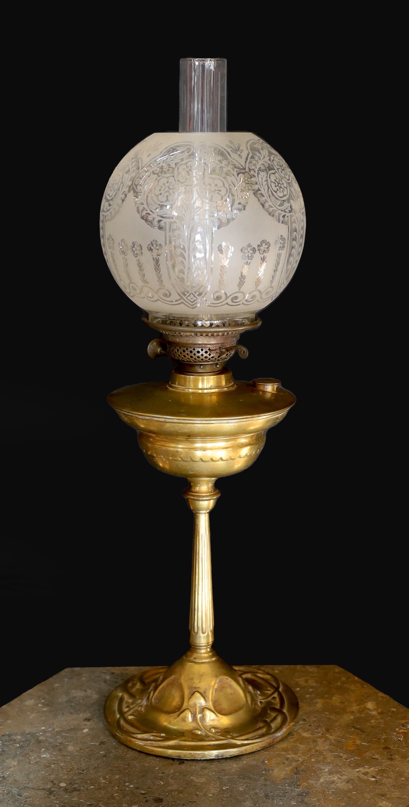An Edwardian brass oil lamp, with etched glass globe, duplex mechanism and Art Nouveau embossed base, height to top of shade 58cm                                                                                           