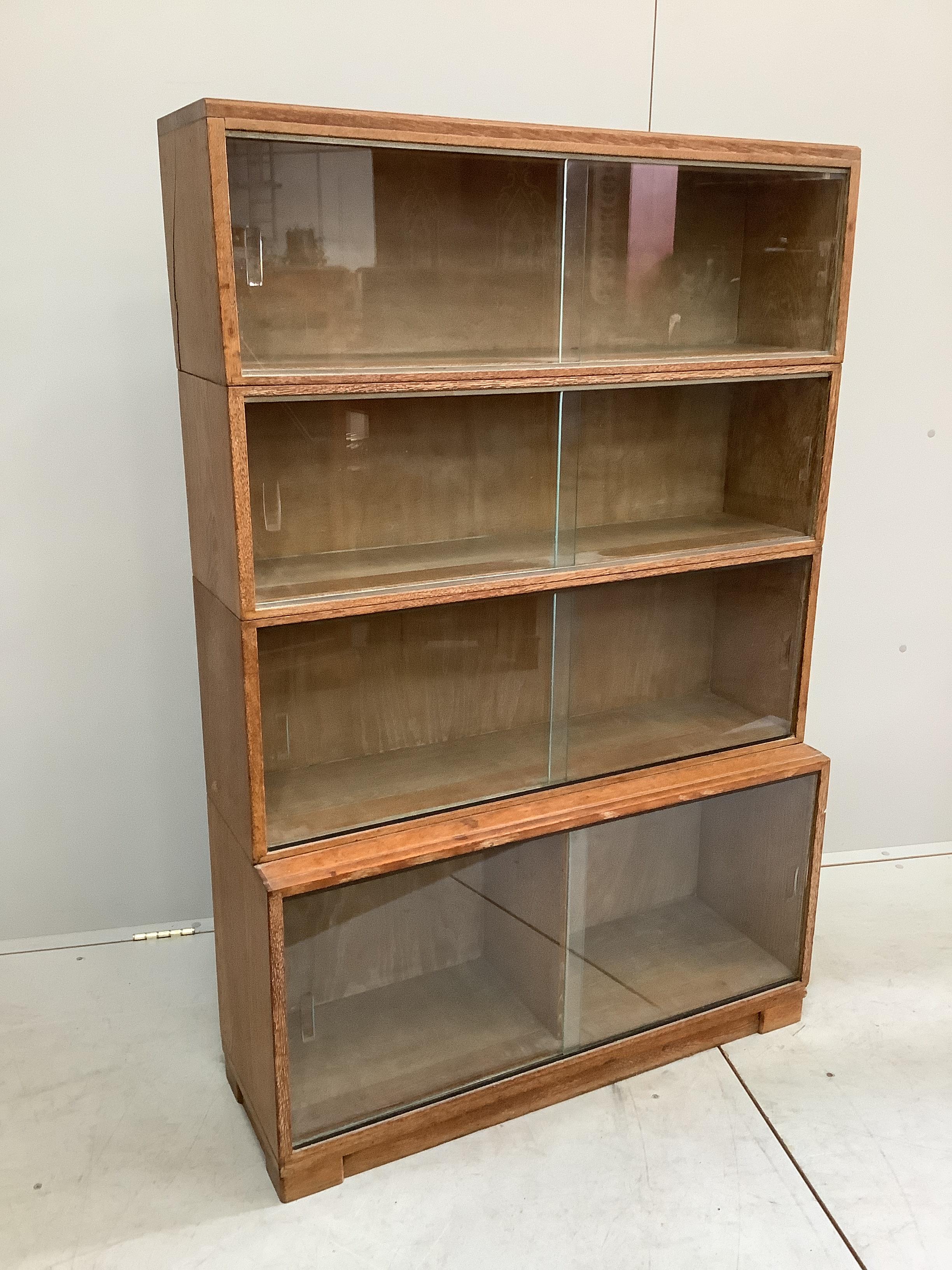 A Minty four section oak glazed bookcase, width 89cm, depth 30cm, height 134cm                                                                                                                                              