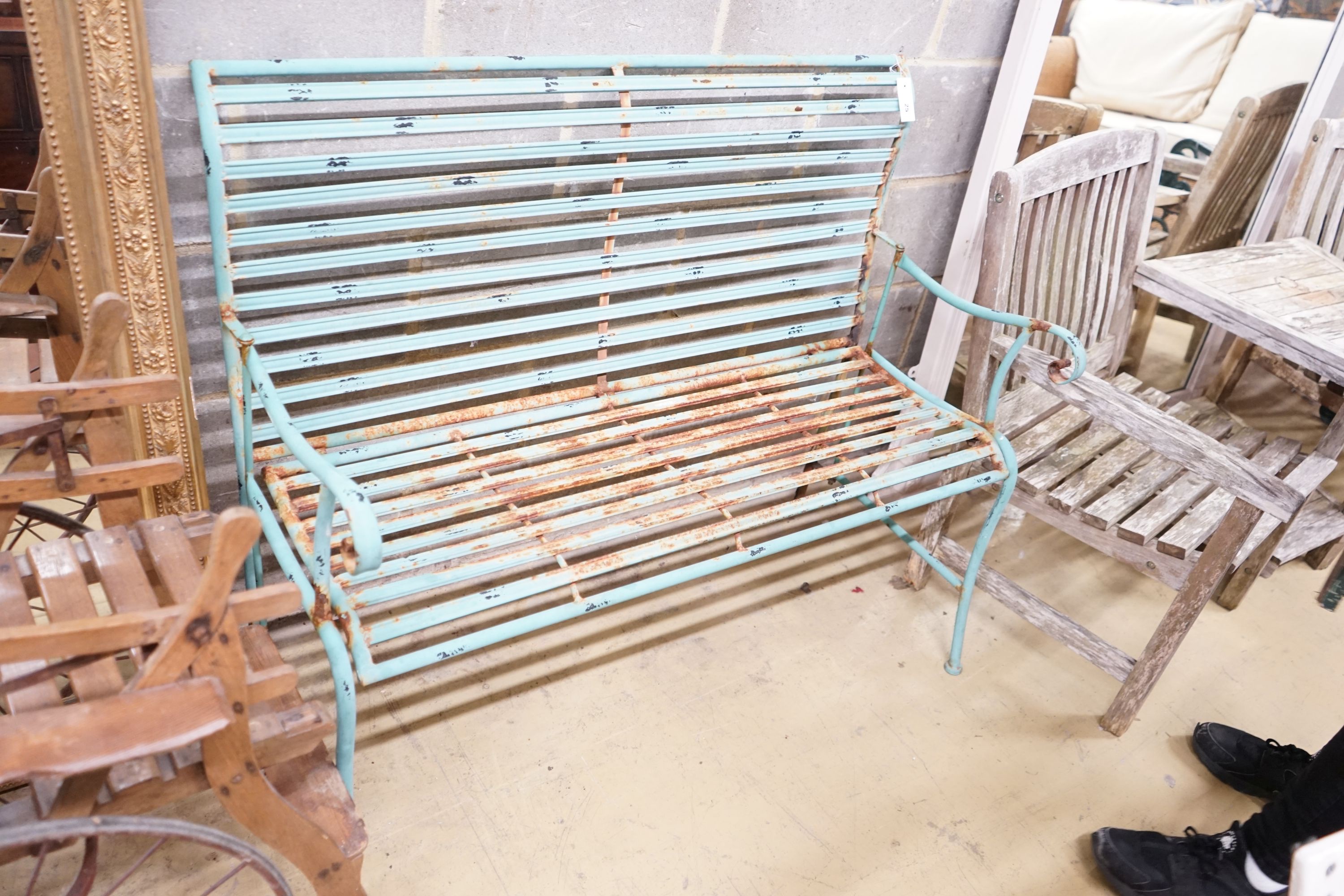 A painted wrought iron folding garden bench, 113cm, depth 55cm, height 92cm                                                                                                                                                 