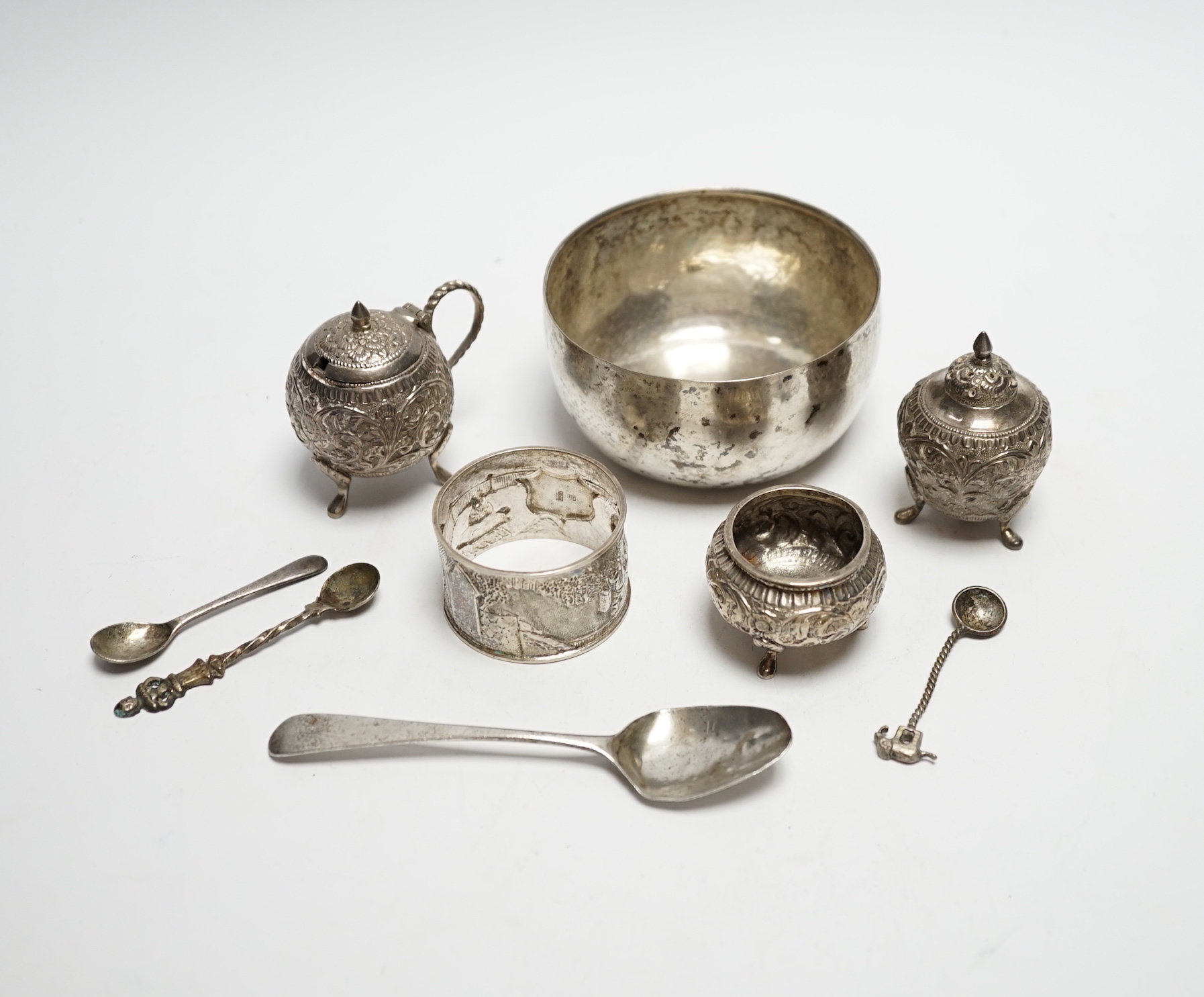 A Thai white metal bowl, diameter 82mm, a Chinese white metal napkin ring, a white metal three piece cruet set and four assorted spoons including George IV teaspoon by William Bateman.                                    