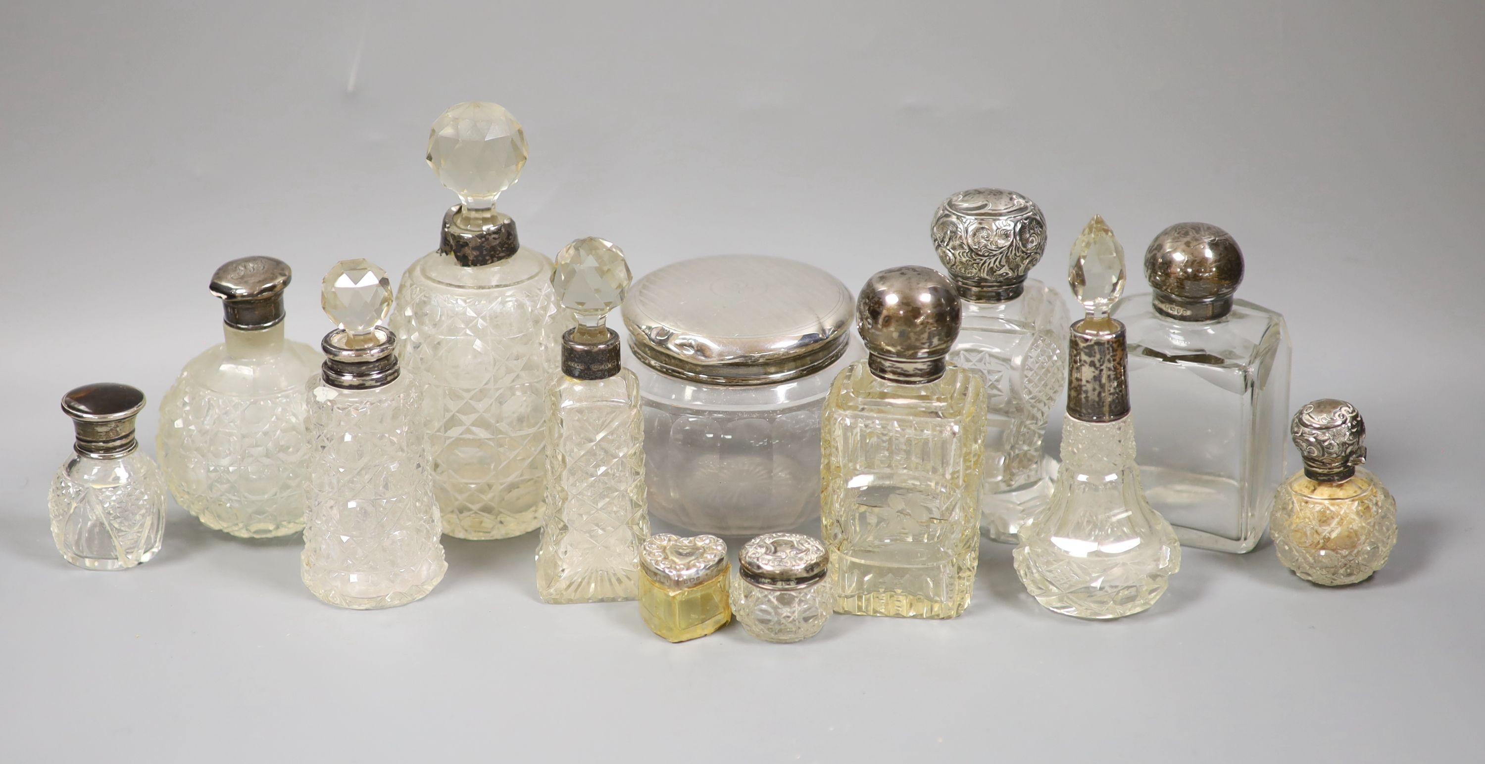 A collection of assorted silver mounted glass scent bottles, toilet jars etc. (a.f.)                                                                                                                                        