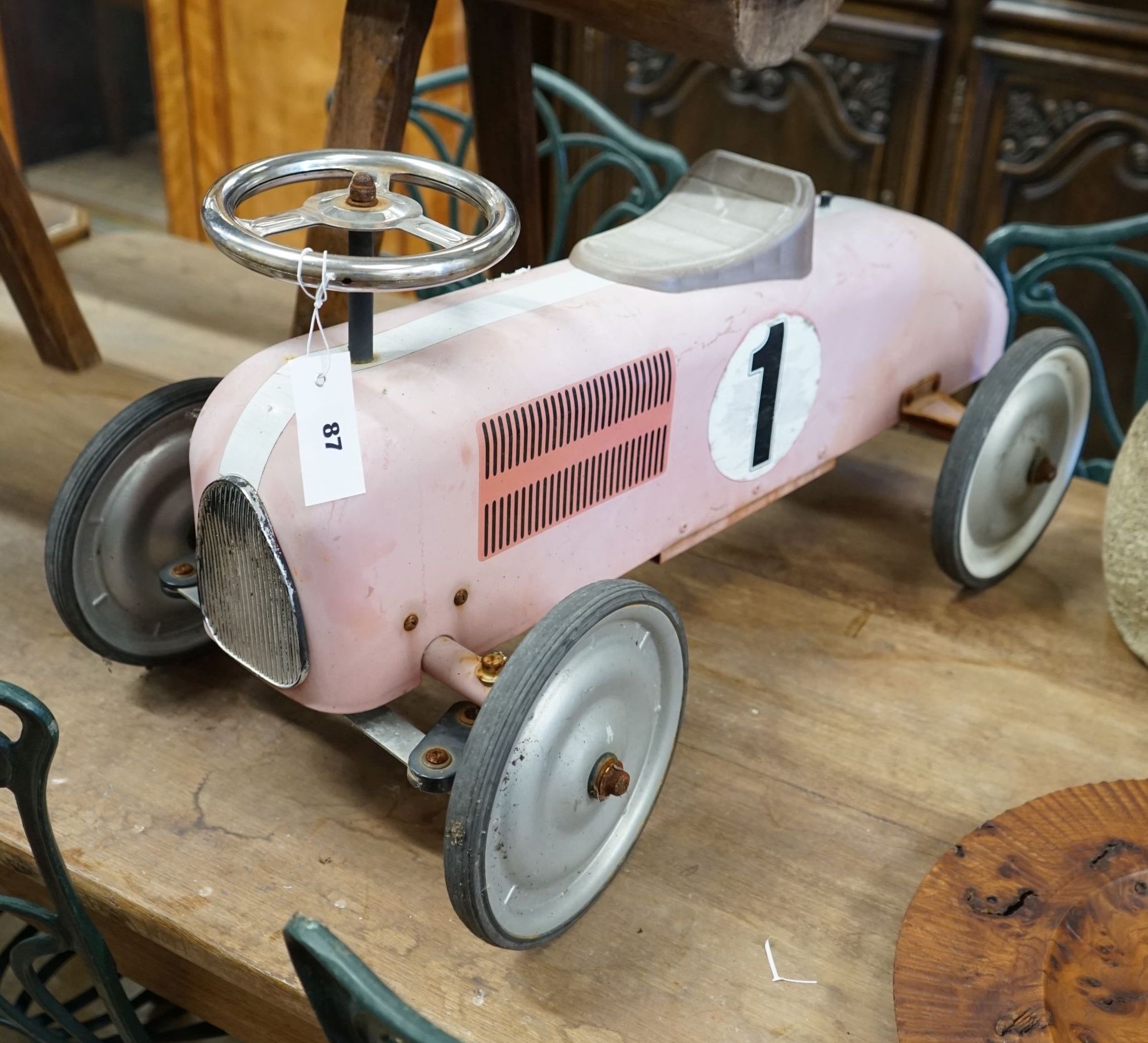 A child's sit-on toy racing car                                                                                                                                                                                             