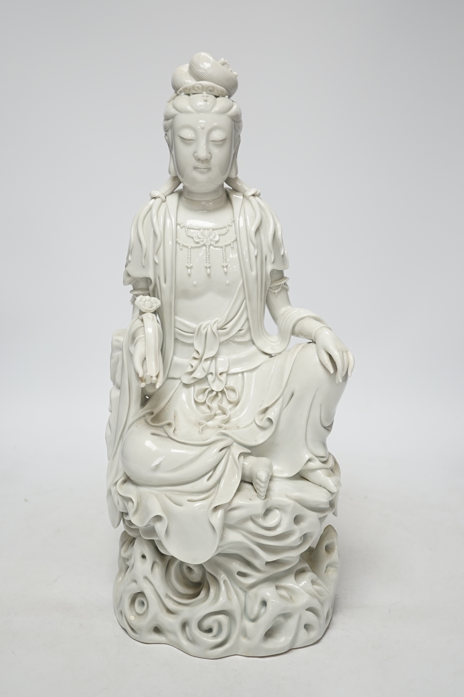 A late 19th / early 20th century Chinese blanc de Chine seated figure of Guanyin, impressed mark to back, 38cm                                                                                                              