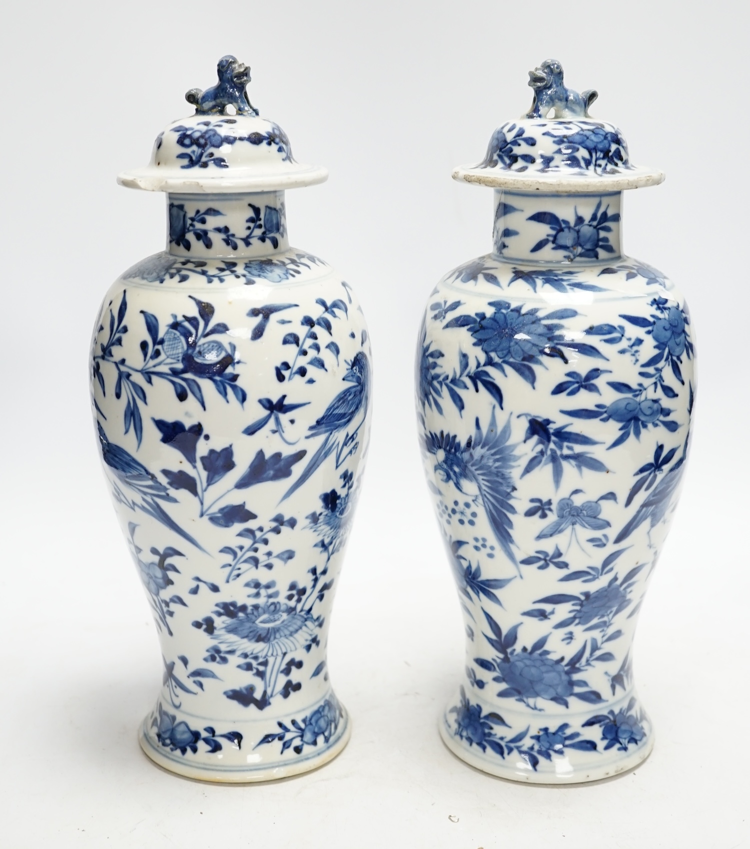 A pair Chinese blue and white vases, late 19th century, with lion-dog covers, 32cm high                                                                                                                                     