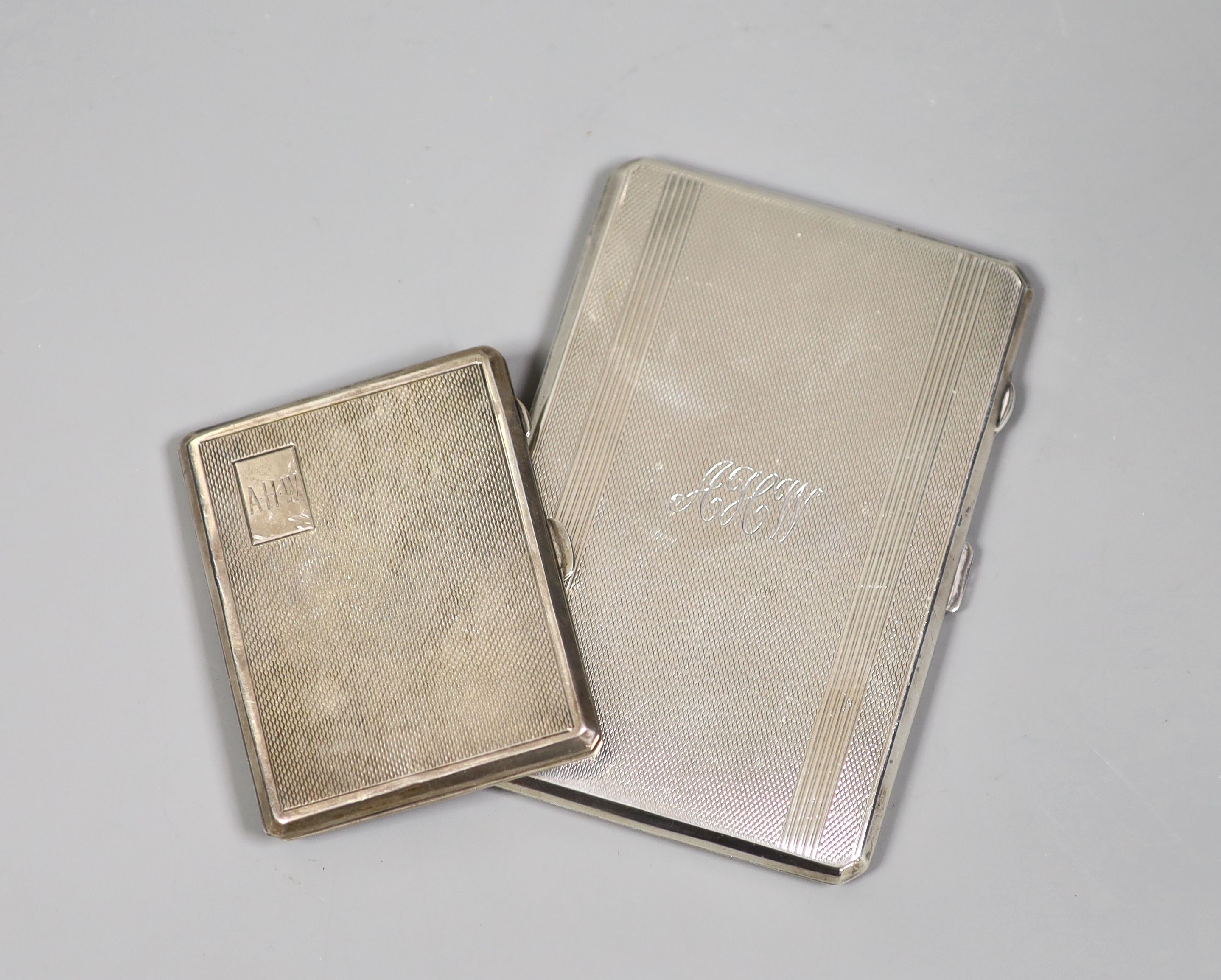 A sterling rectangular cigarette case, 12.6cm and a smaller silver cigarette case, gross 8oz.                                                                                                                               