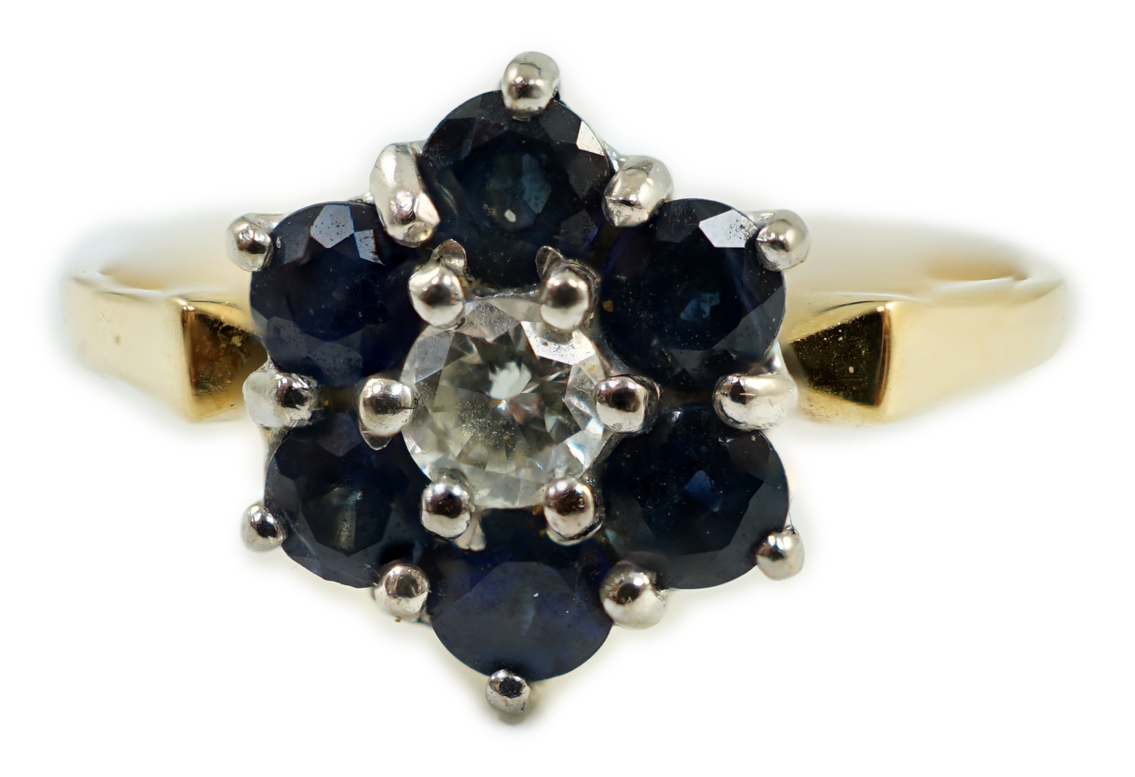 A modern 18ct gold, sapphire and diamond cluster set ring, size Q, gross weight 2.9 grams.                                                                                                                                  