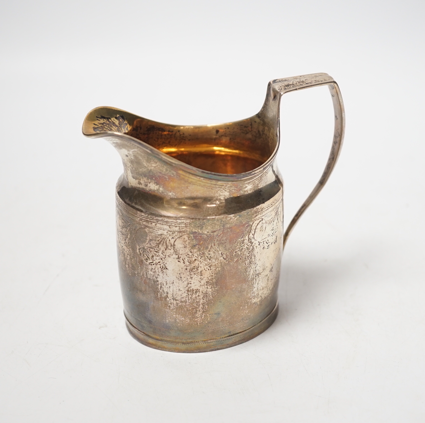 A George III silver cream jug, marks rubbed, 10.3cm.                                                                                                                                                                        