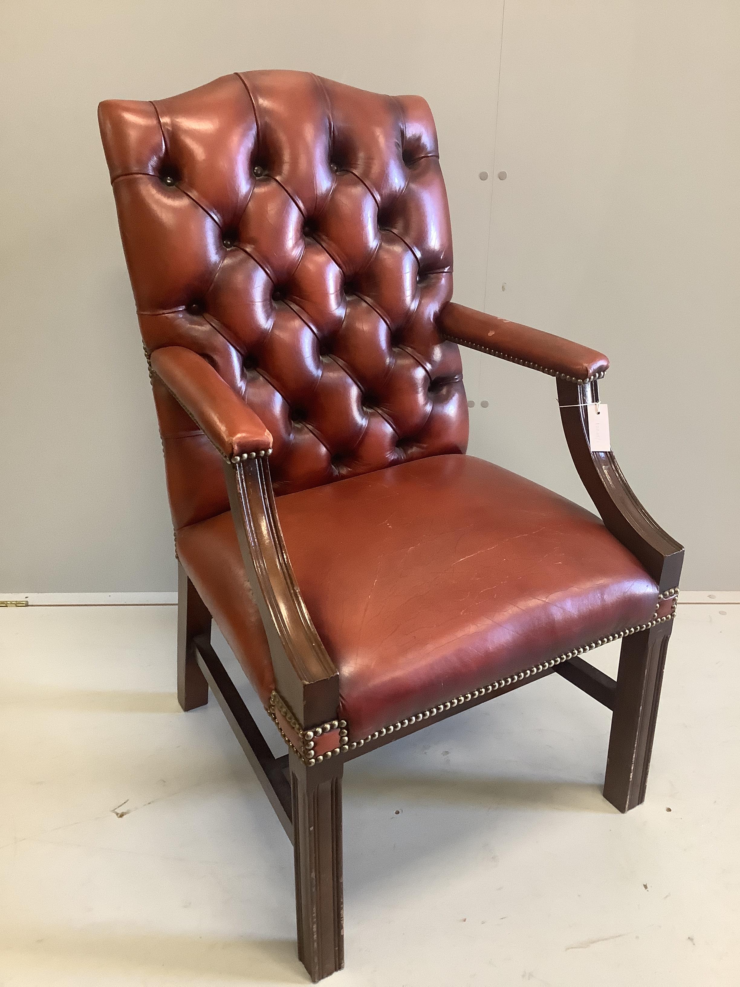 A reproduction mahogany Gainsborough type library chair with buttoned leather upholstery, width 60cm, depth 68cm, height 101cm                                                                                              
