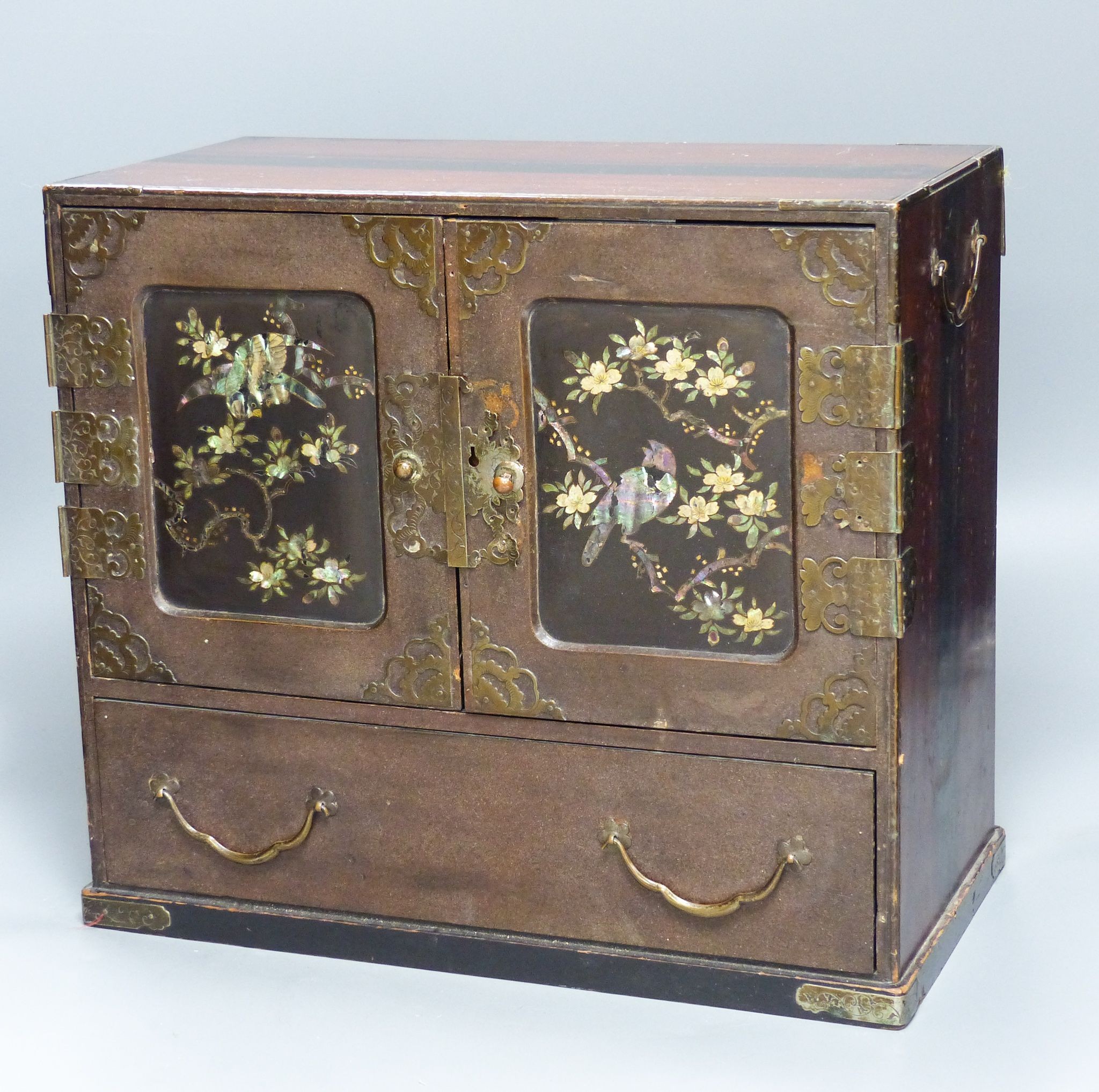 A Japanese lacquer and abalone inlaid table cabinet, 36.5cm wide                                                                                                                                                            