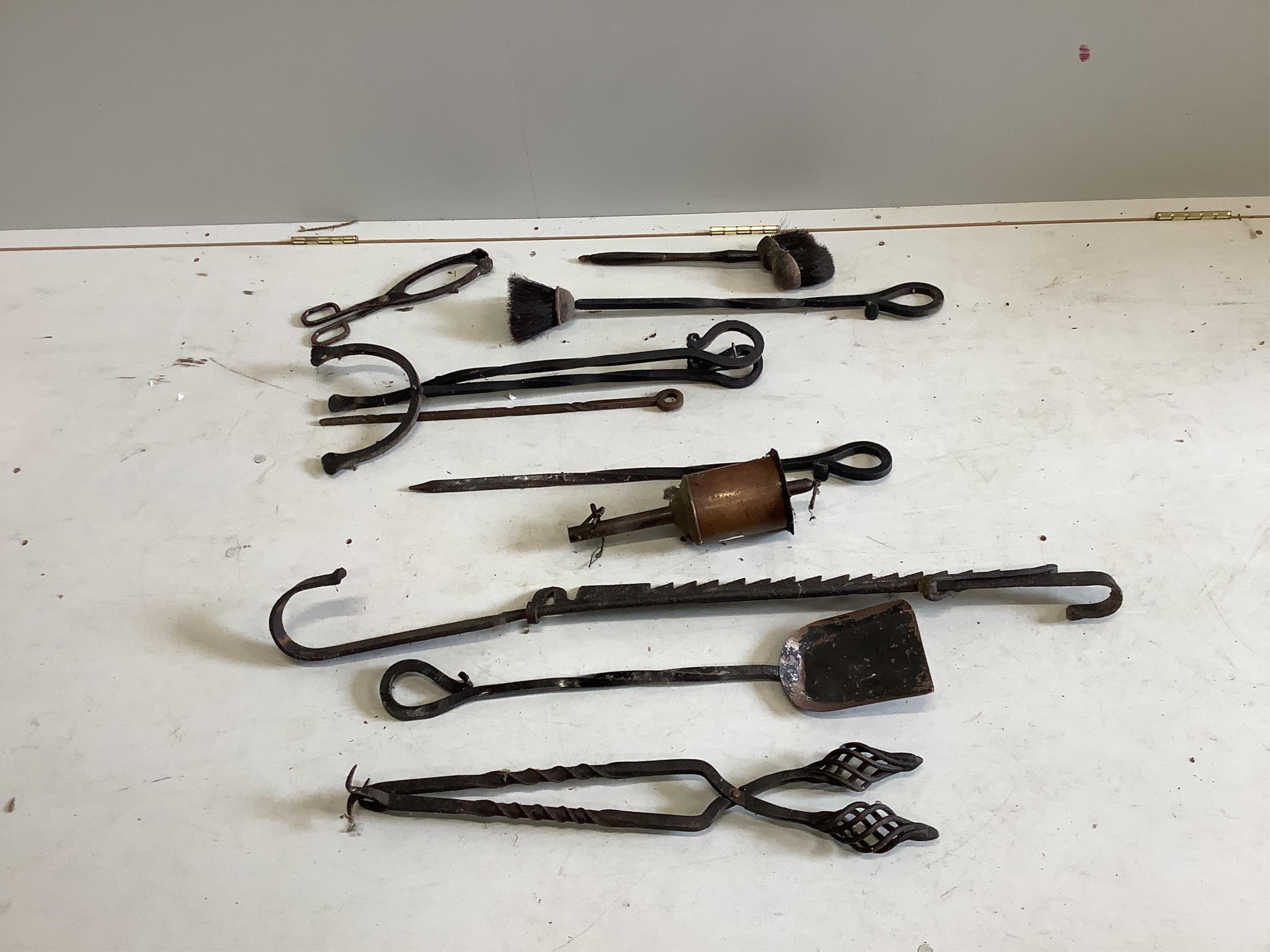 An 18th century wrought iron adjustable pot rack, a collection of fire irons and a brass spit jack. Condition - poor-fair                                                                                                   