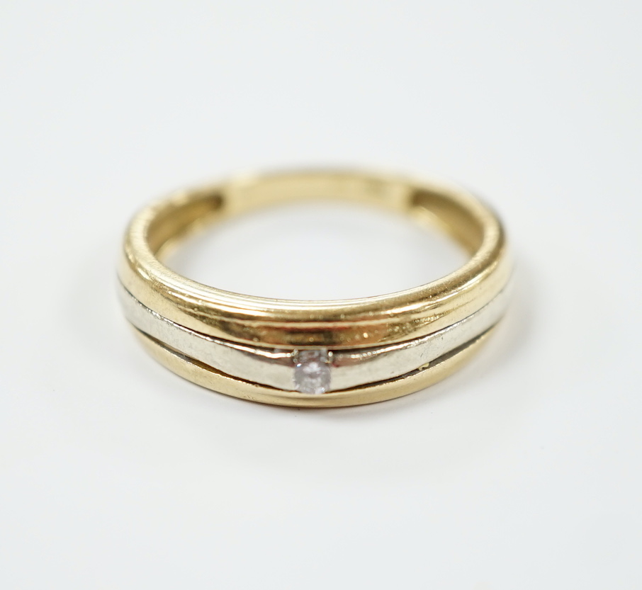 A two colour 750 yellow metal and single stone diamond chip set ring, size L, gross weight 3.3 grams.                                                                                                                       