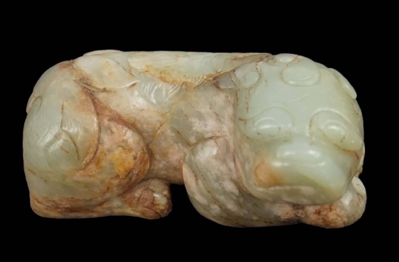 A Chinese celadon and a russet jade figure of a recumbent lion-dog, 17th century                                                                                                                                            