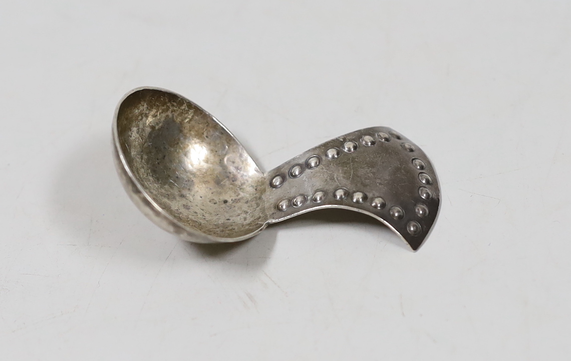 A George V Arts & Crafts silver caddy spoon, by the Keswick Scholl of Industrial Art, with beaded handle, Chester, 1912, 60mm.                                                                                              