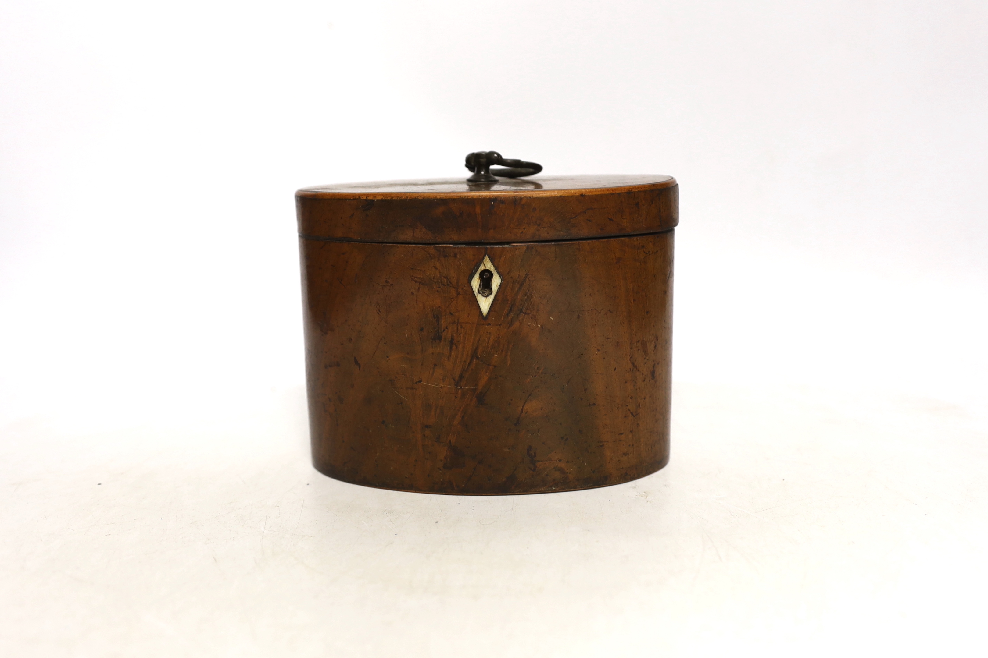 A George III oval mahogany tea caddy with bone lock escutcheon, 12cm high                                                                                                                                                   