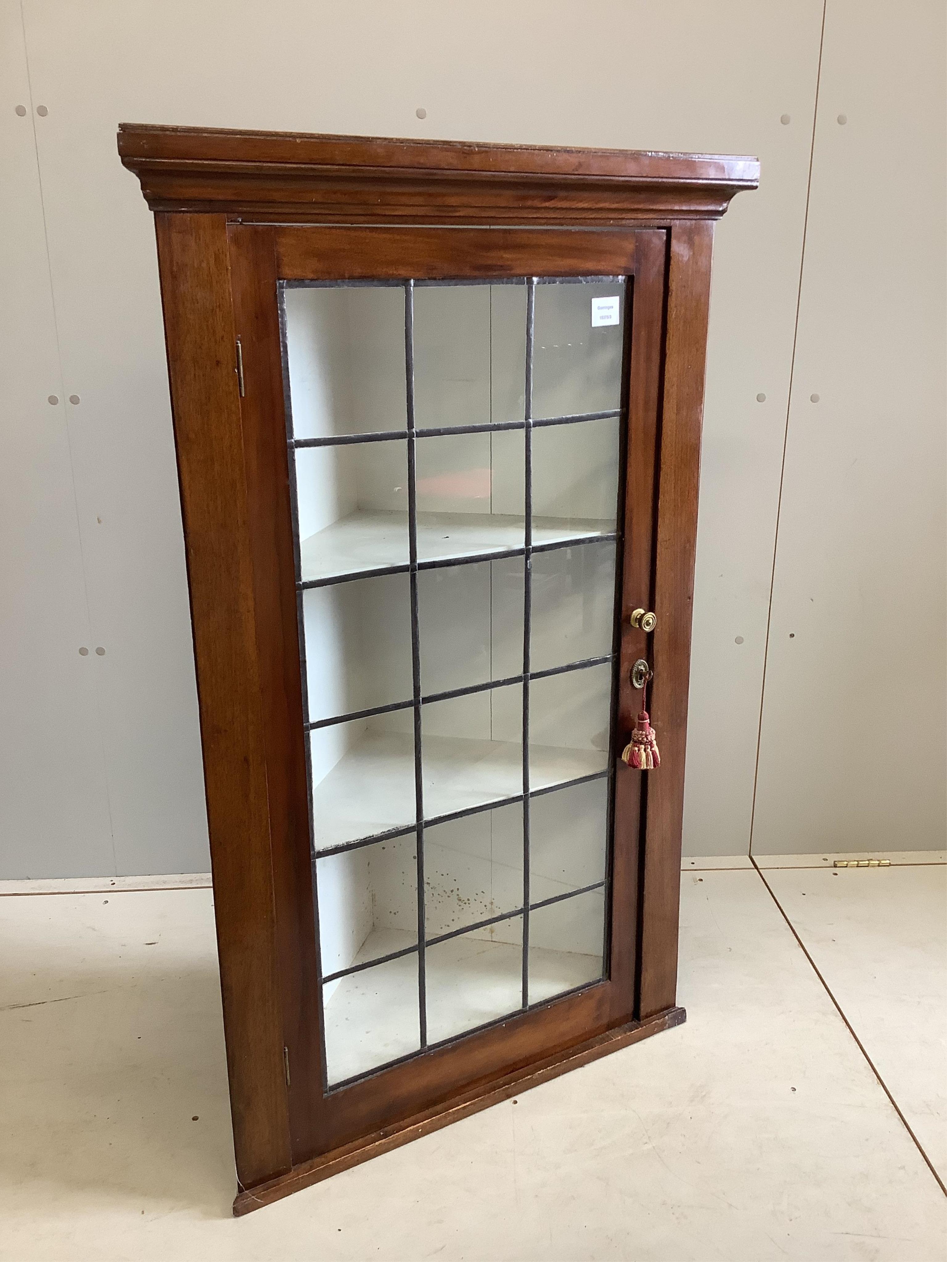 A George III style glazed mahogany hanging corner cabinet, with leaded glazing bars, width 77cm, depth 38cm, height 124cm. Condition - fair                                                                                 