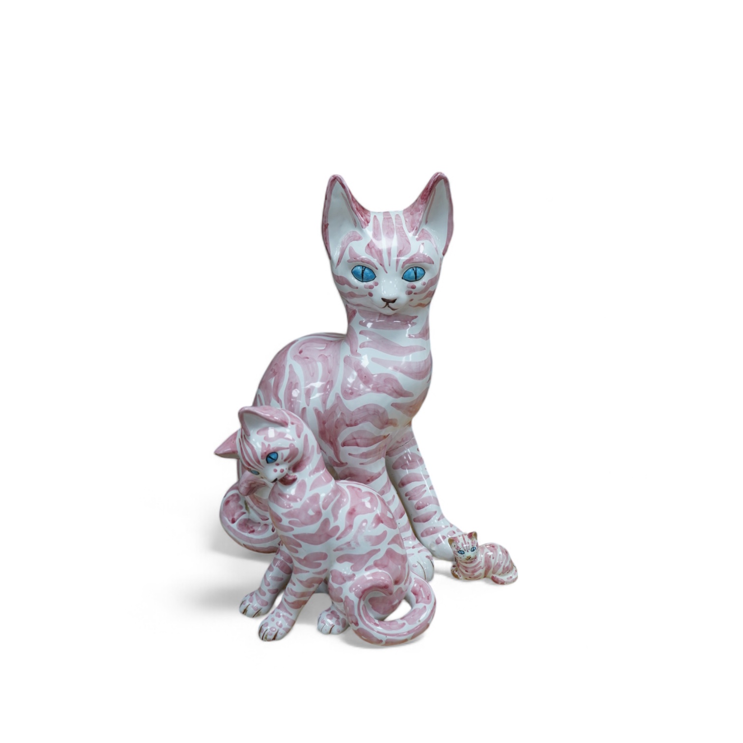 A large 1950's Italian pink maiolica seated cat and two smaller, largest 45cm. Condition - poor                                                                                                                             