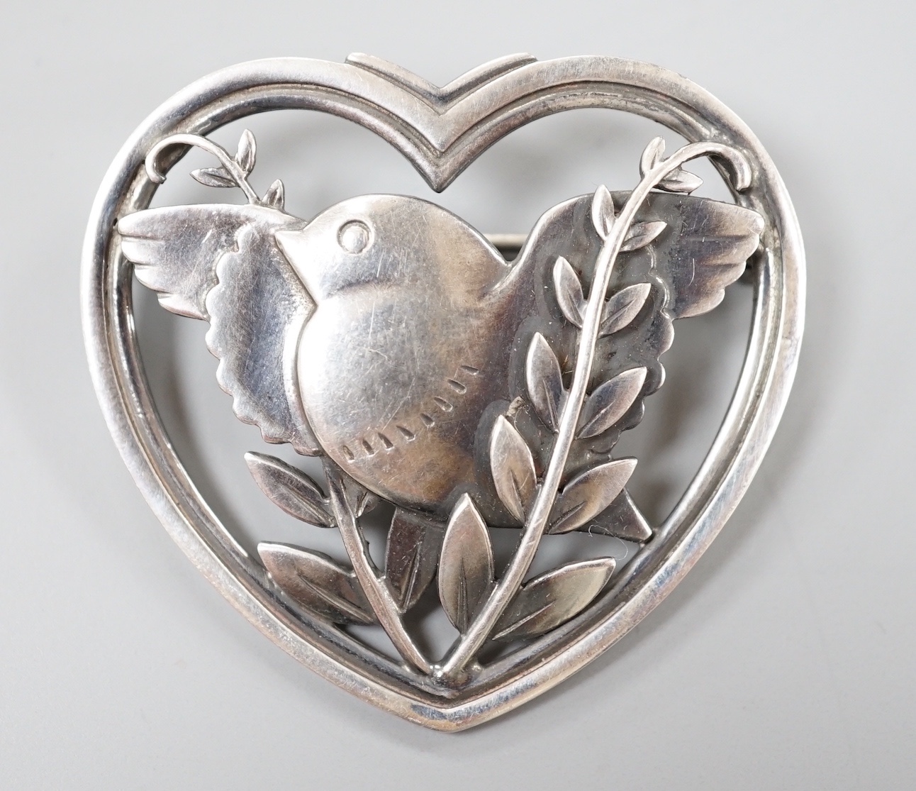 A Georg Jensen sterling 'robin and frond' heart shaped brooch, no. 239, 37mm.                                                                                                                                               