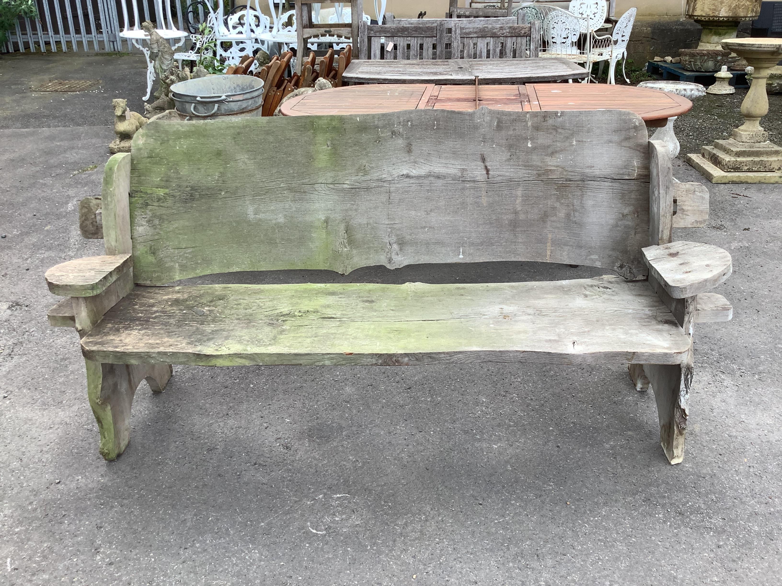 A rustic elm garden bench, width 195cm, depth 62cm, height 92cm                                                                                                                                                             