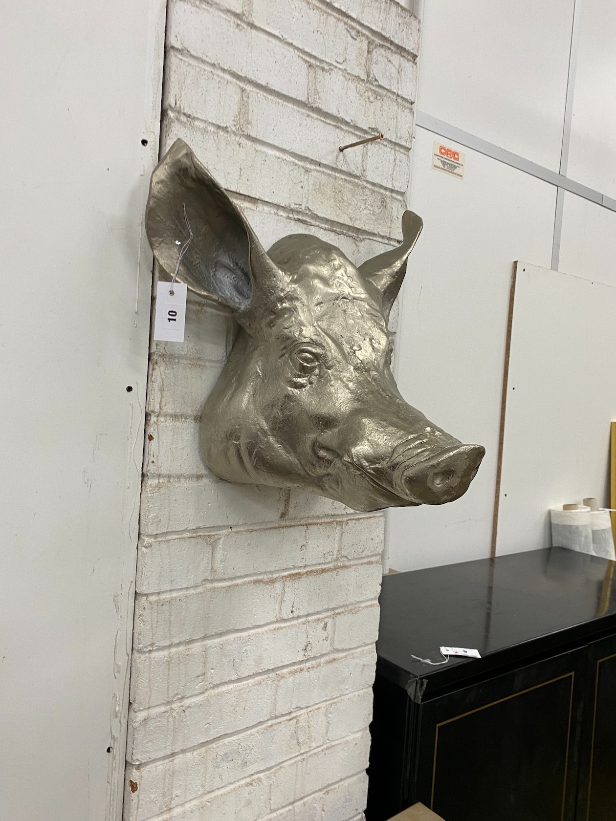 A cast metal wall mounted pigs head ornament, height 44cm                                                                                                                                                                   