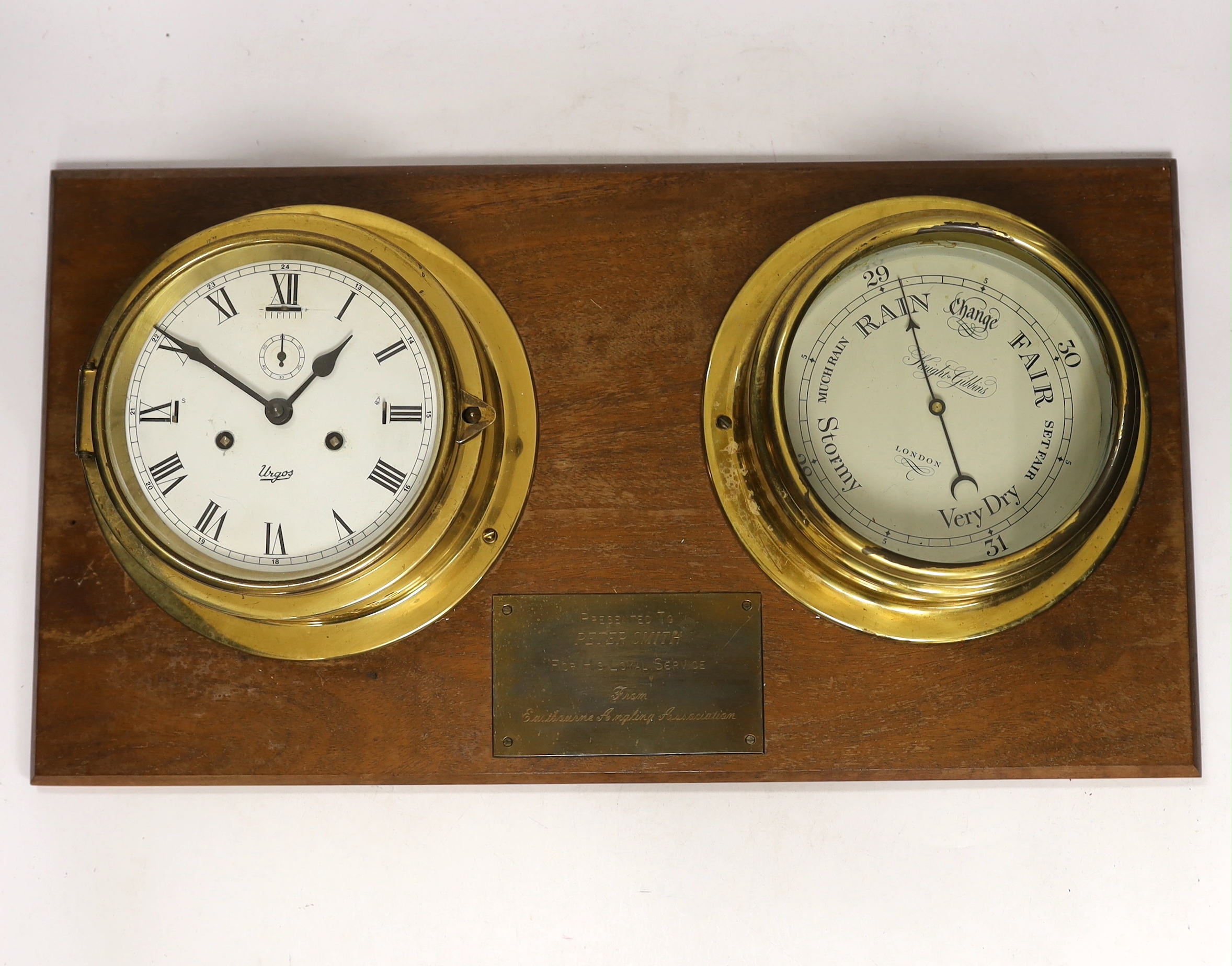 A brass mounted barometer and bulkhead clock with presentation plaque, 56cm wide                                                                                                                                            