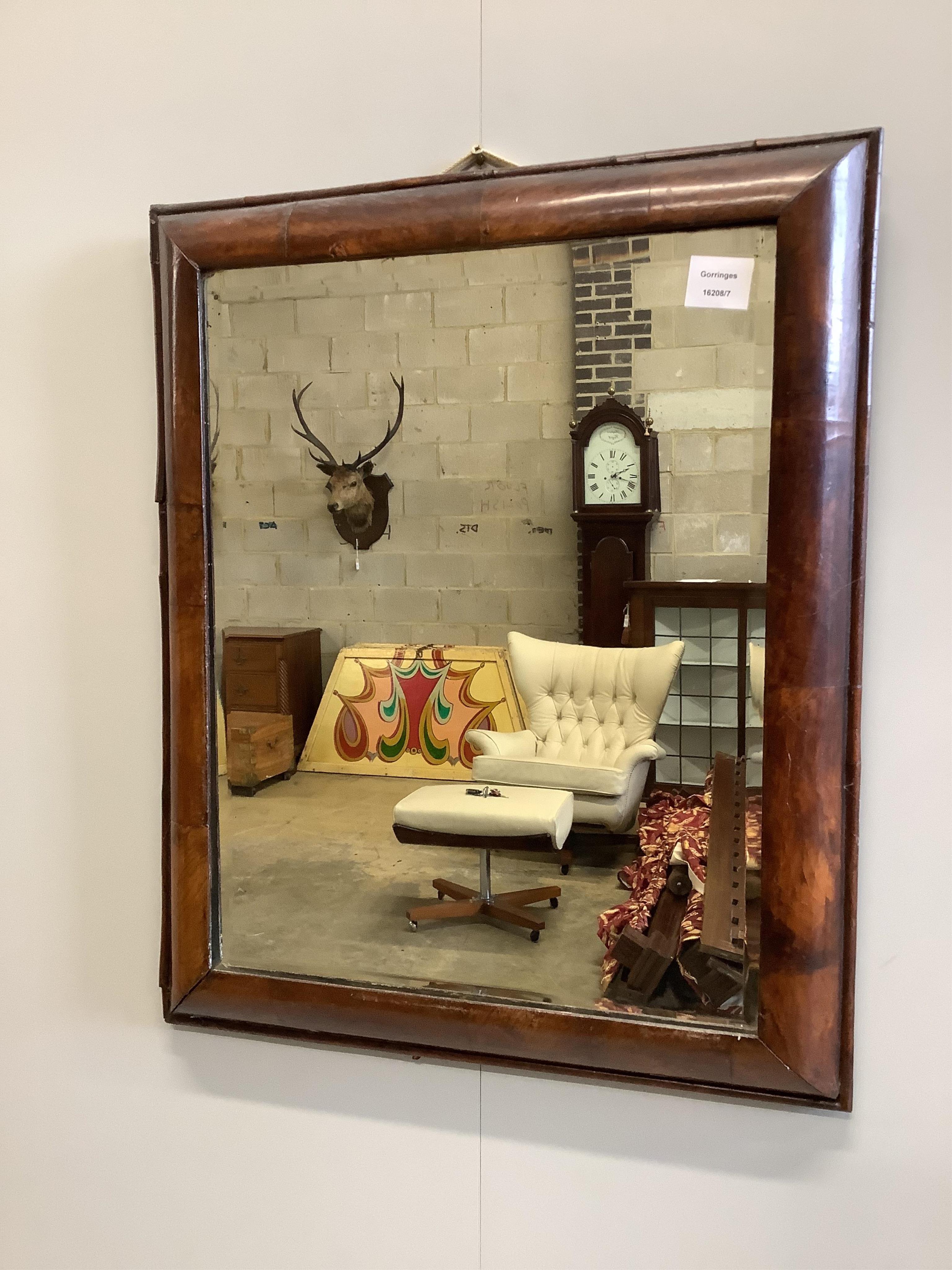 A Queen Anne rectangular walnut cushion framed wall mirror, with later bevelled glass plate, width 53cm, height 64cm. Condition - fair                                                                                      