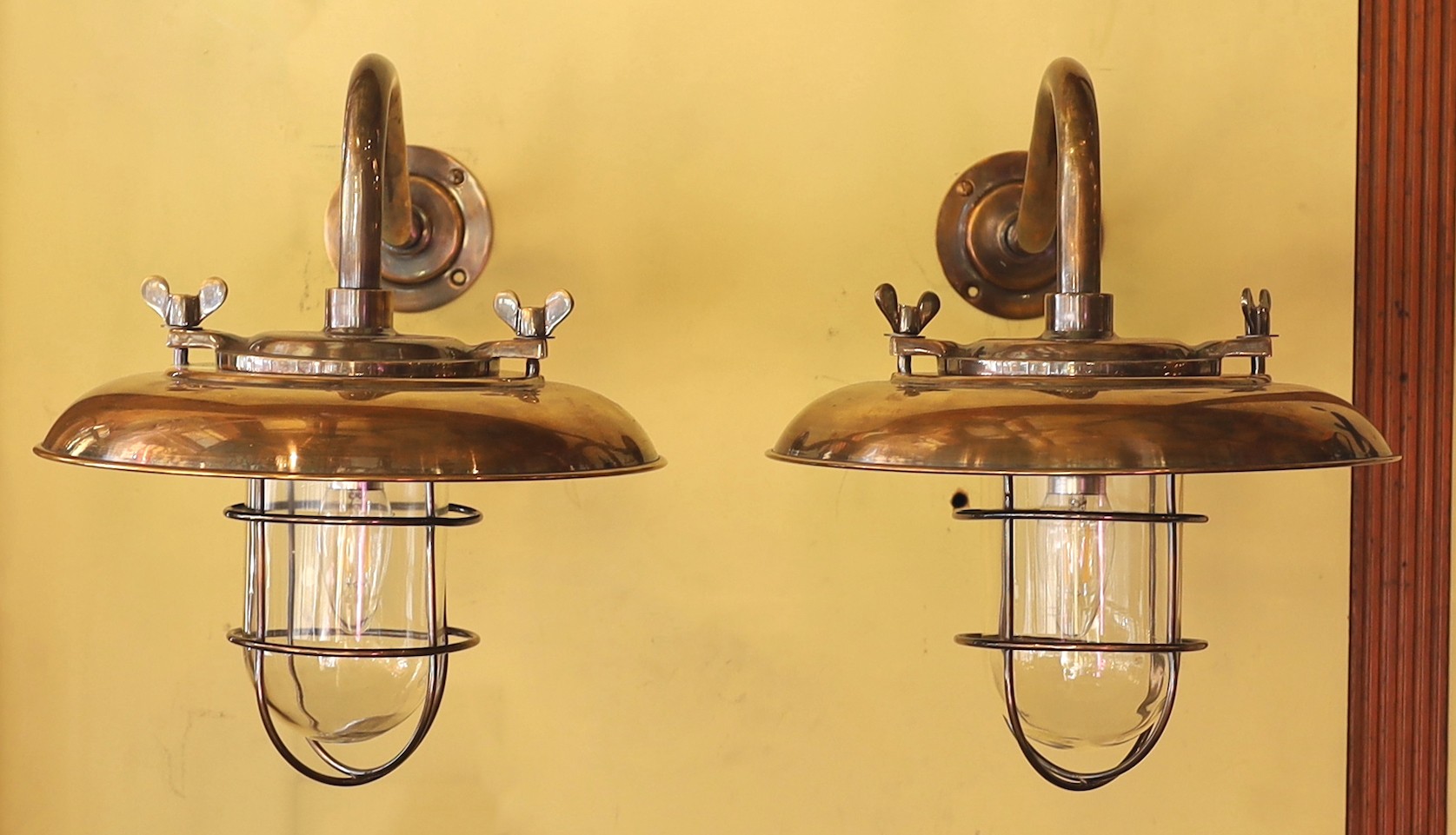 A pair of nautical style bronzed metal wall lights, height 35cm. diameter 35cm                                                                                                                                              