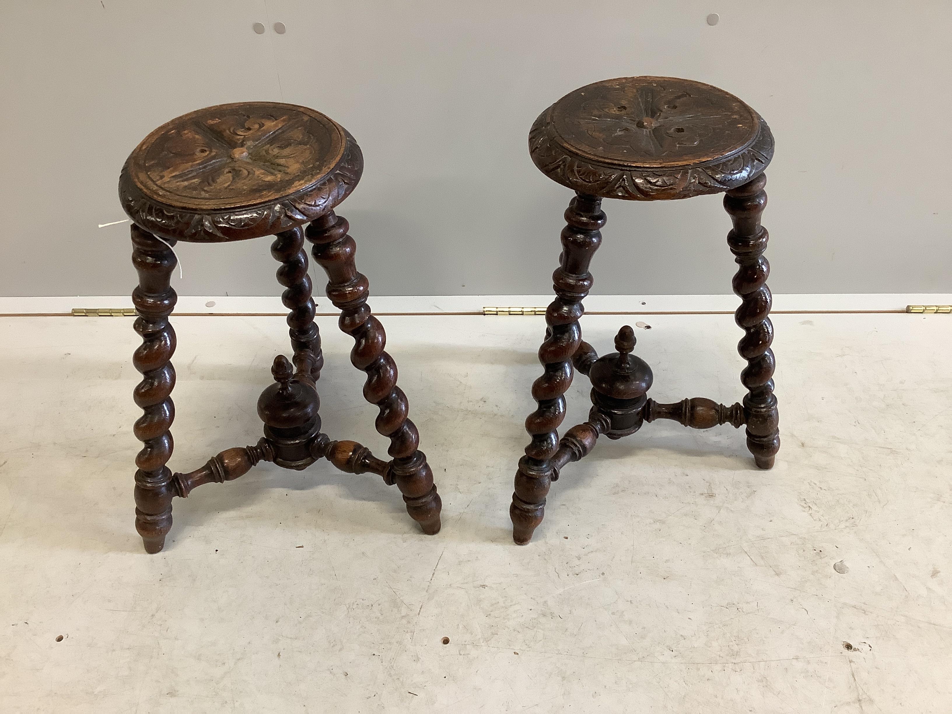 A pair of late Victorian carved and turned oak stools, height 48cm                                                                                                                                                          