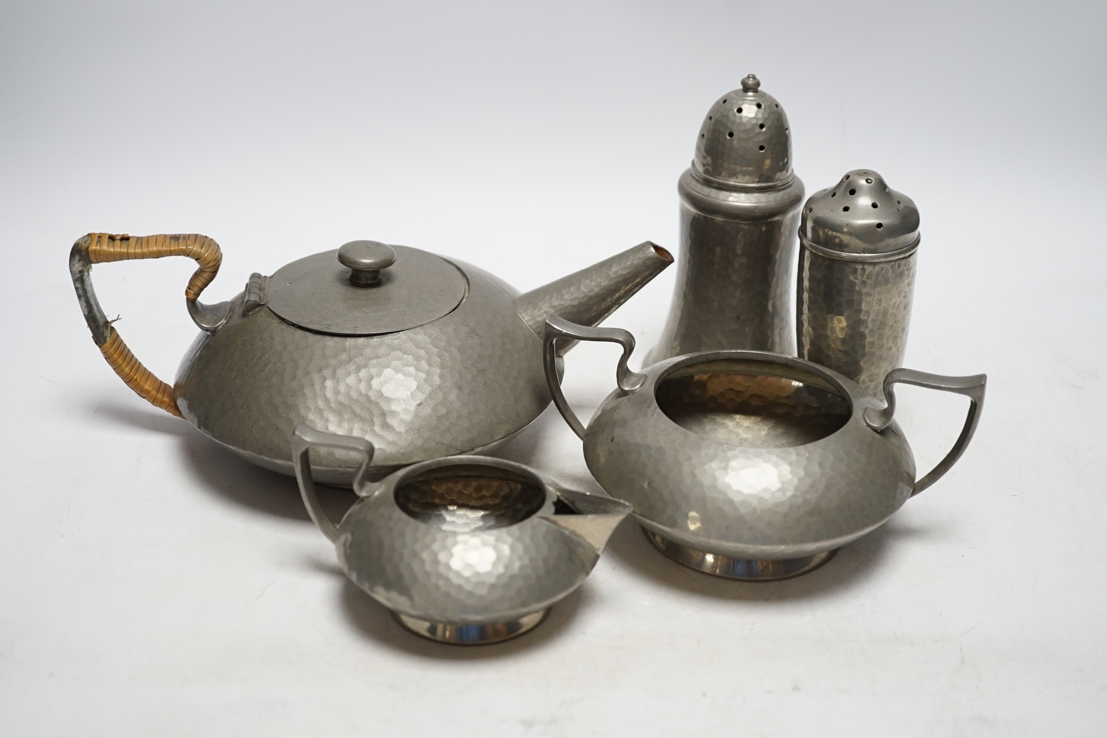 A Hutton Sheffield English Pewter tea set comprising of a teapot, 8cm high, jug and sugar bowl, together with salt and pepper shakers by other makers                                                                       