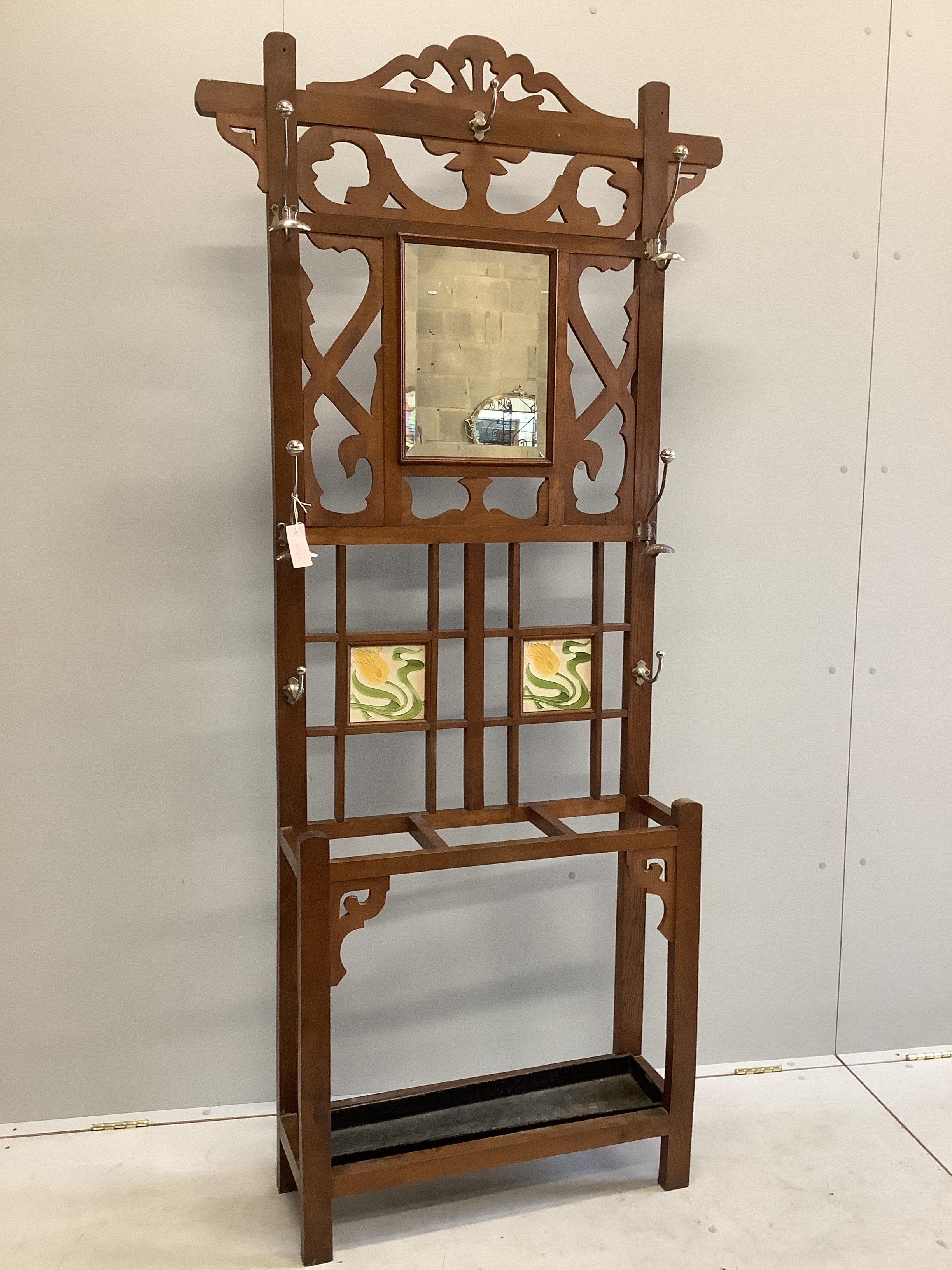 A late Victorian oak mirrored and tile back hallstand, width 94cm, height 200cm                                                                                                                                             