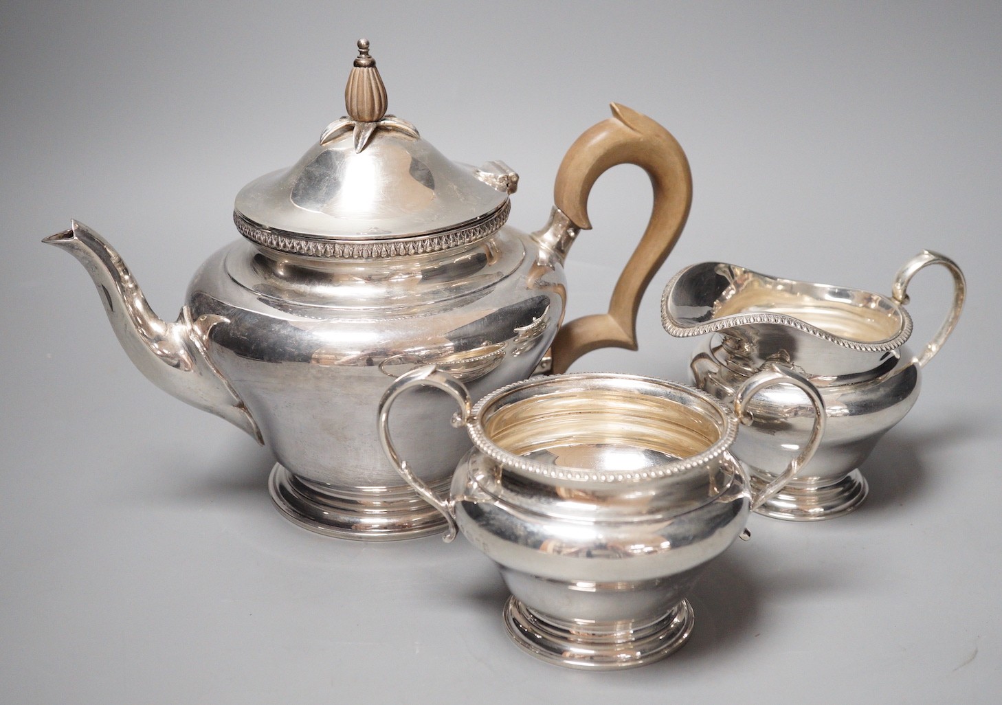 A George V silver inverted pear shape three piece tea set, Edward Barnard & Sons Ltd, London 1928/9                                                                                                                         