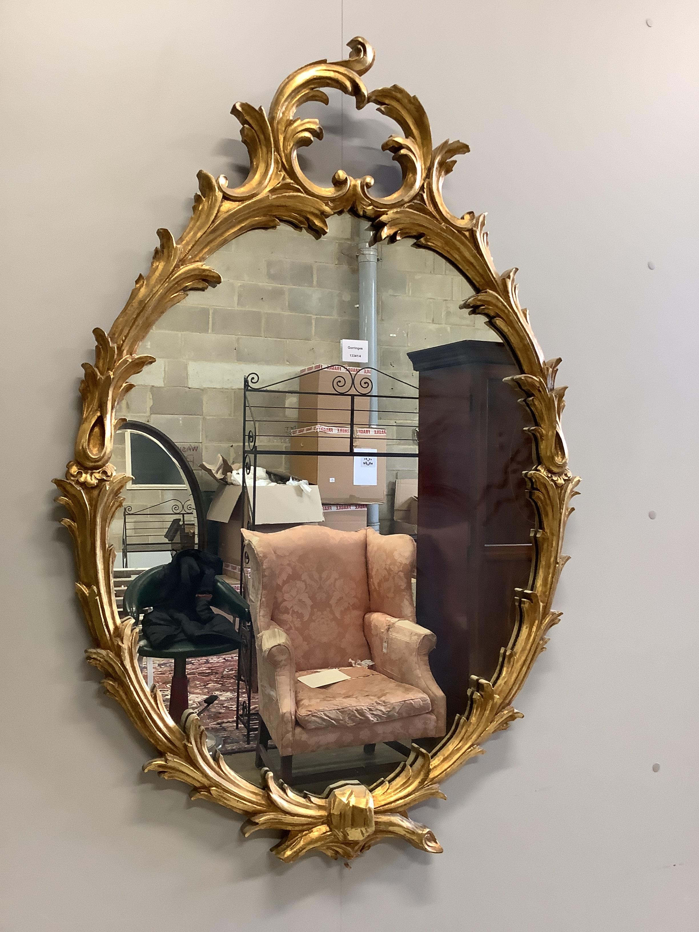 A reproduction giltwood and composition oval wall mirror, width 80cm, height 116cm                                                                                                                                          