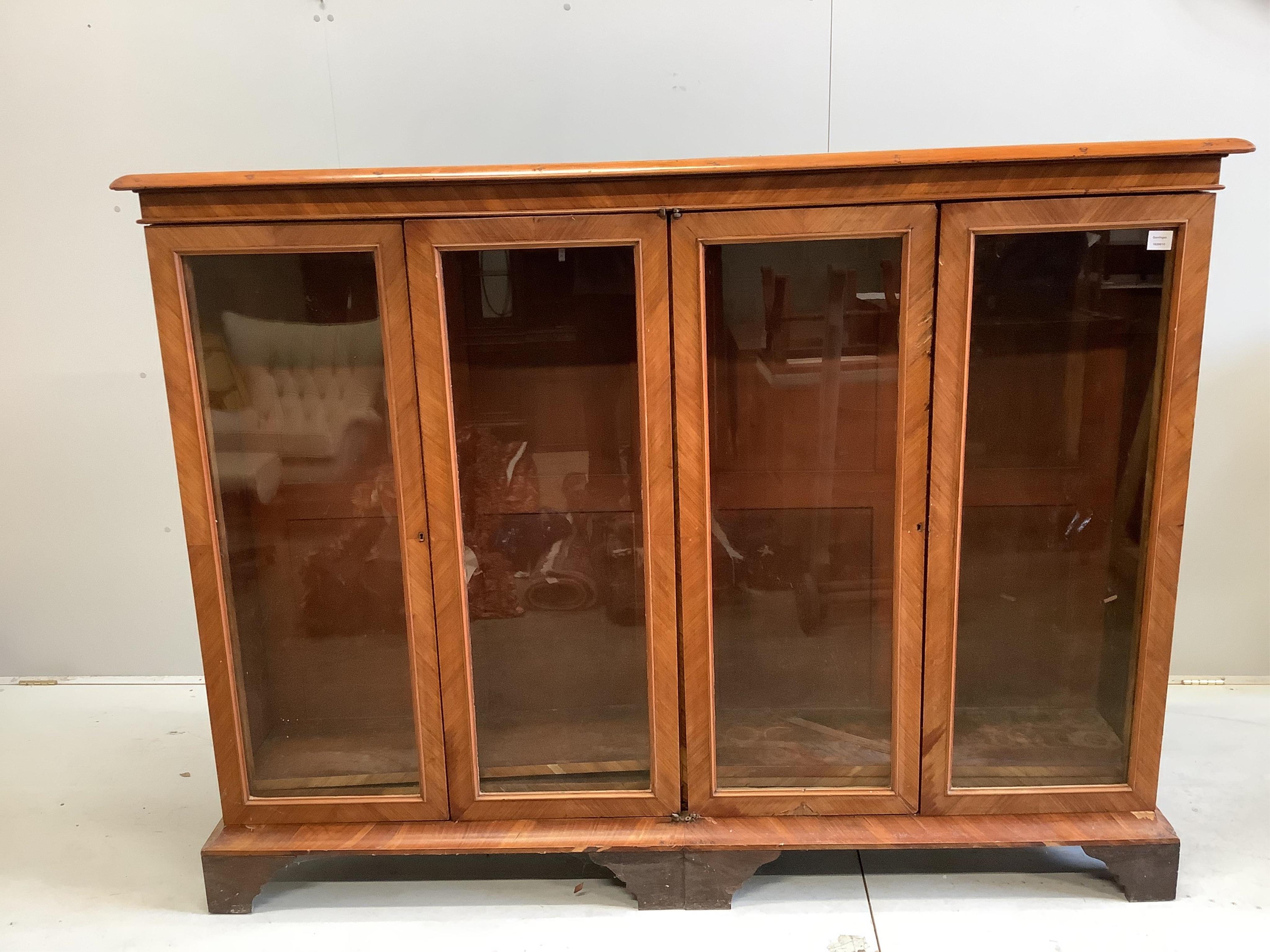 A large 19th century glazed kingwood bookcase, fitted four hinged doors and three adjustable shelves, width 190cm, depth 36cm, height 145cm. Condition - poor                                                               