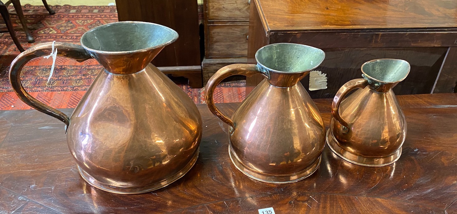 A set of three Victorian copper measures, largest height 29cm                                                                                                                                                               
