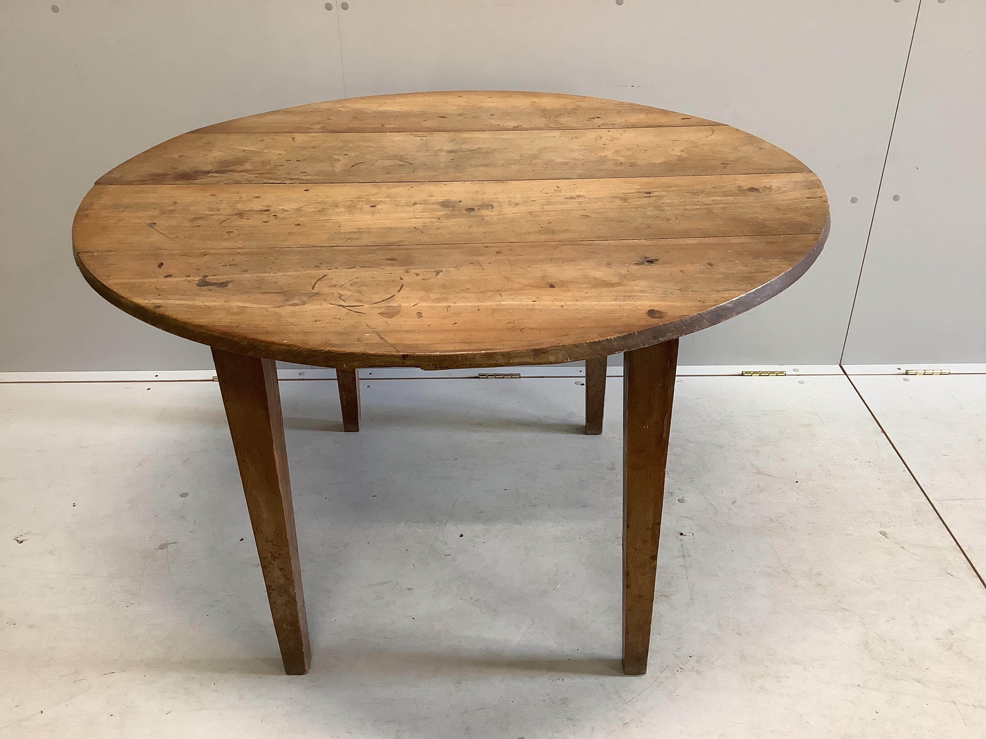 A 19th century French circular cherry kitchen table, diameter 113cm, height 73cm                                                                                                                                            