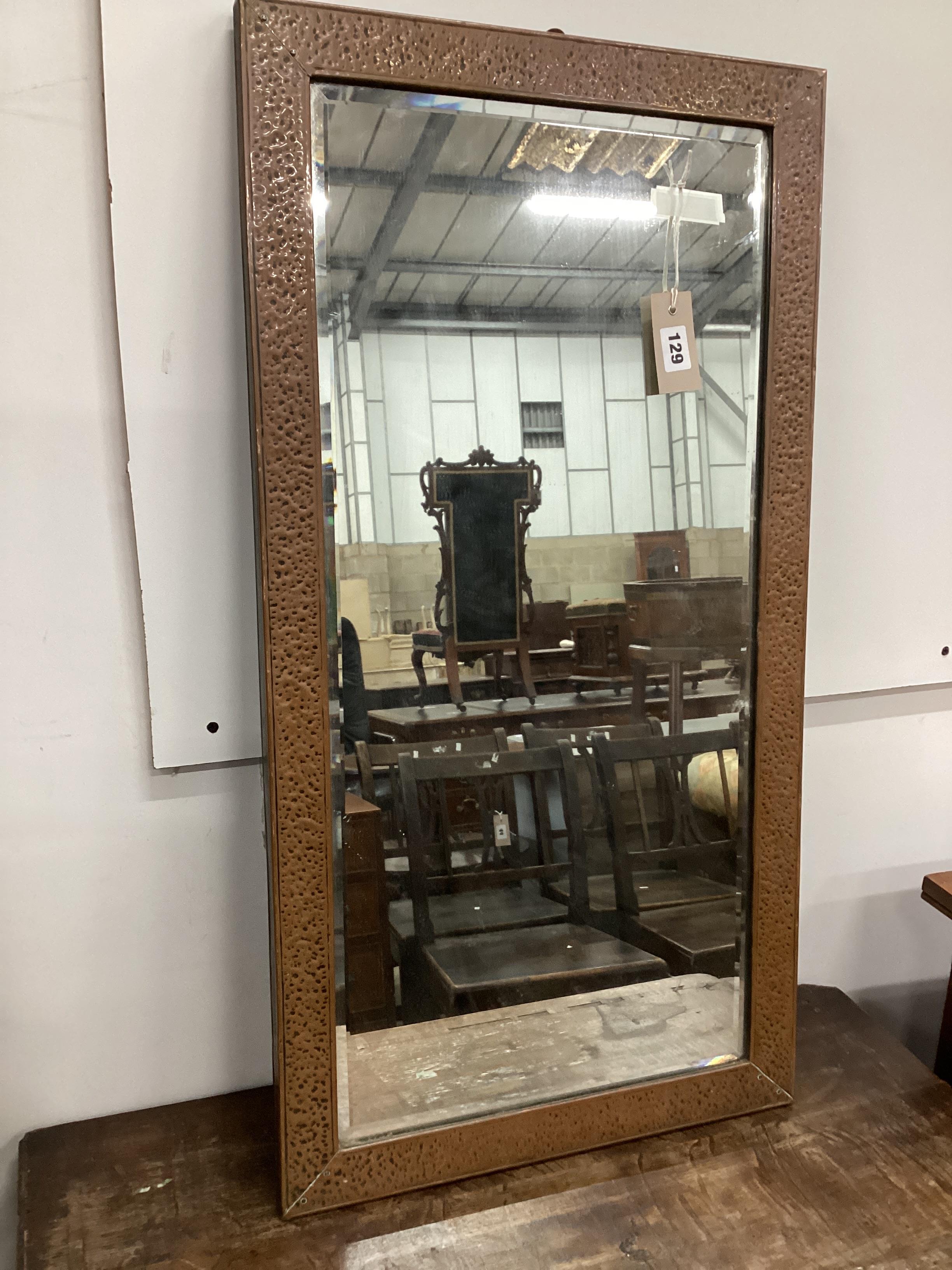 A rectangular Arts & Crafts hammered copper wall mirror, width 43cm, height 81cm                                                                                                                                            