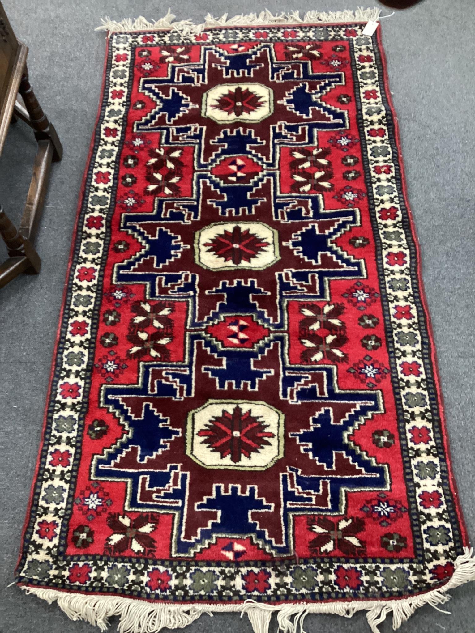 A Caucasian style red ground rug, 180 x 94cm                                                                                                                                                                                