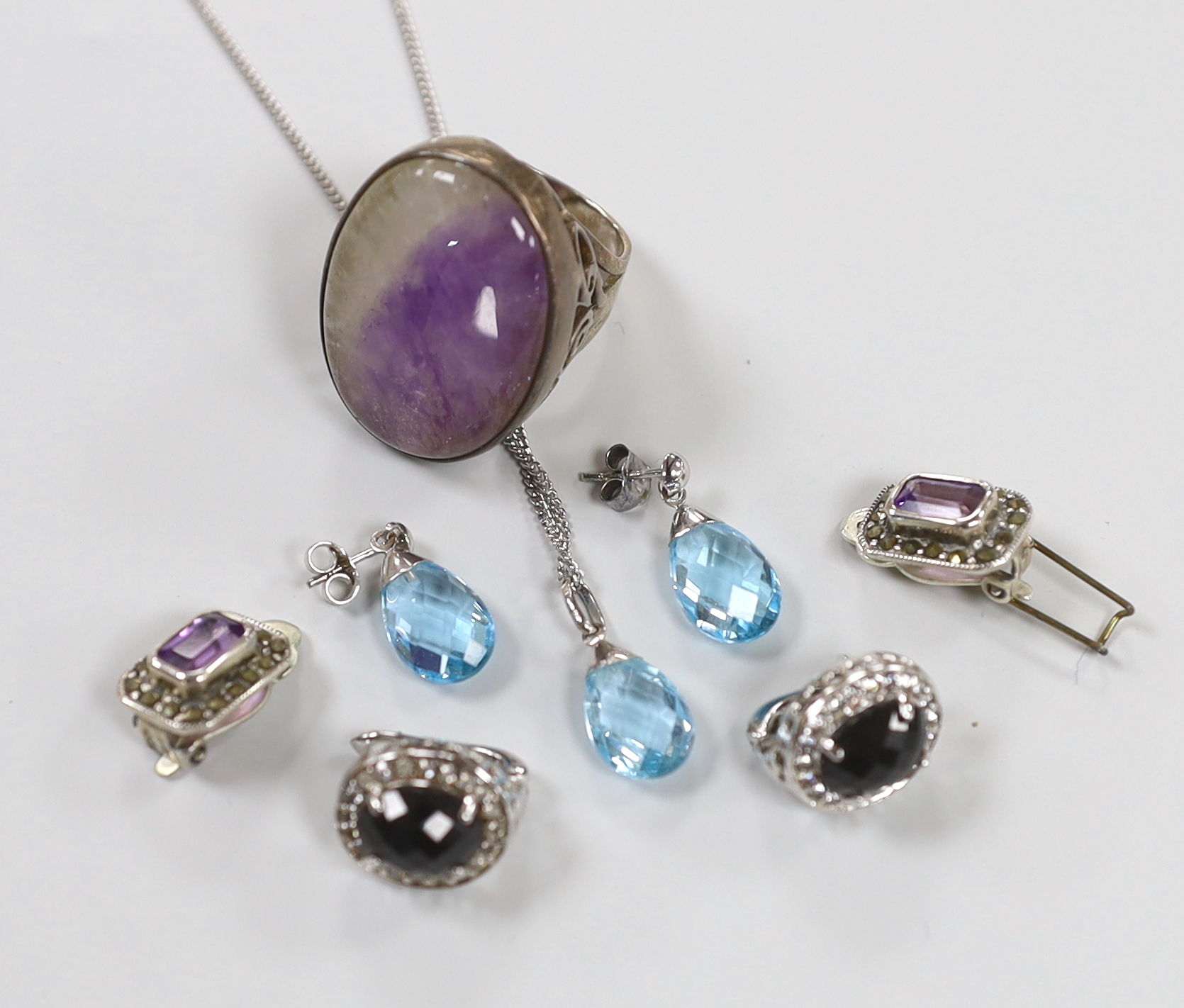 A group of minor costume jewellery comprising silver and blue John ring, size O, a pair of marcasite ear clips, paste set ear clips and a 9ct white gold mounted facetted aquamarine pendant with matching earrings         